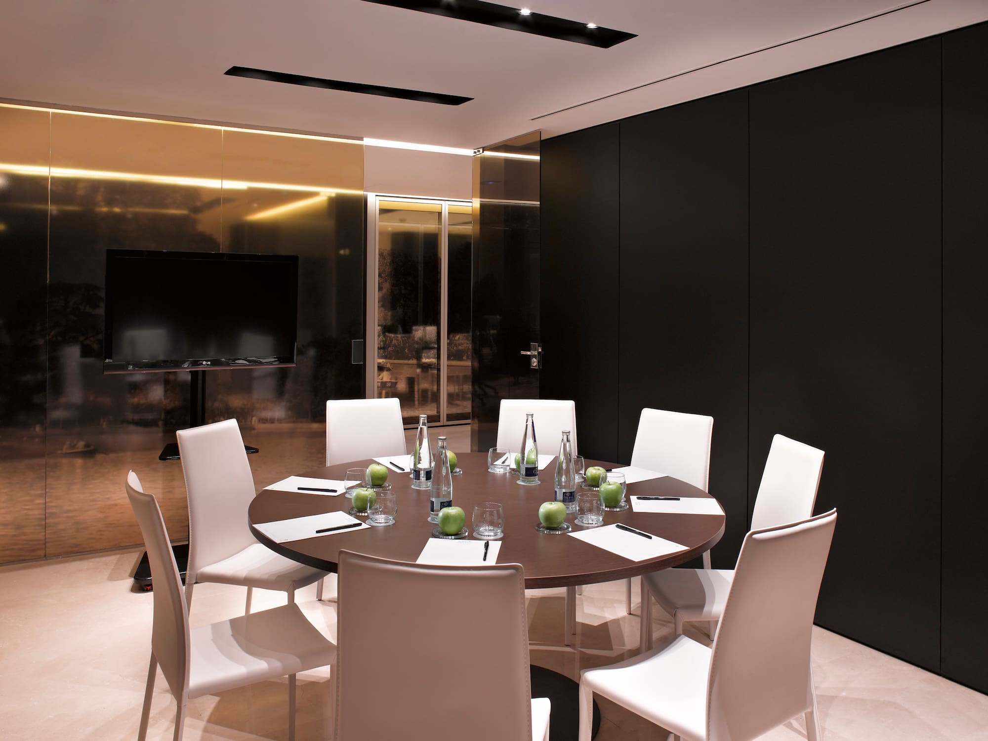 a room with a round table and chairs