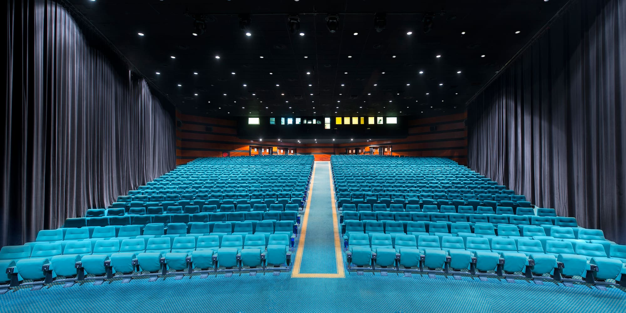 a large auditorium with blue seats