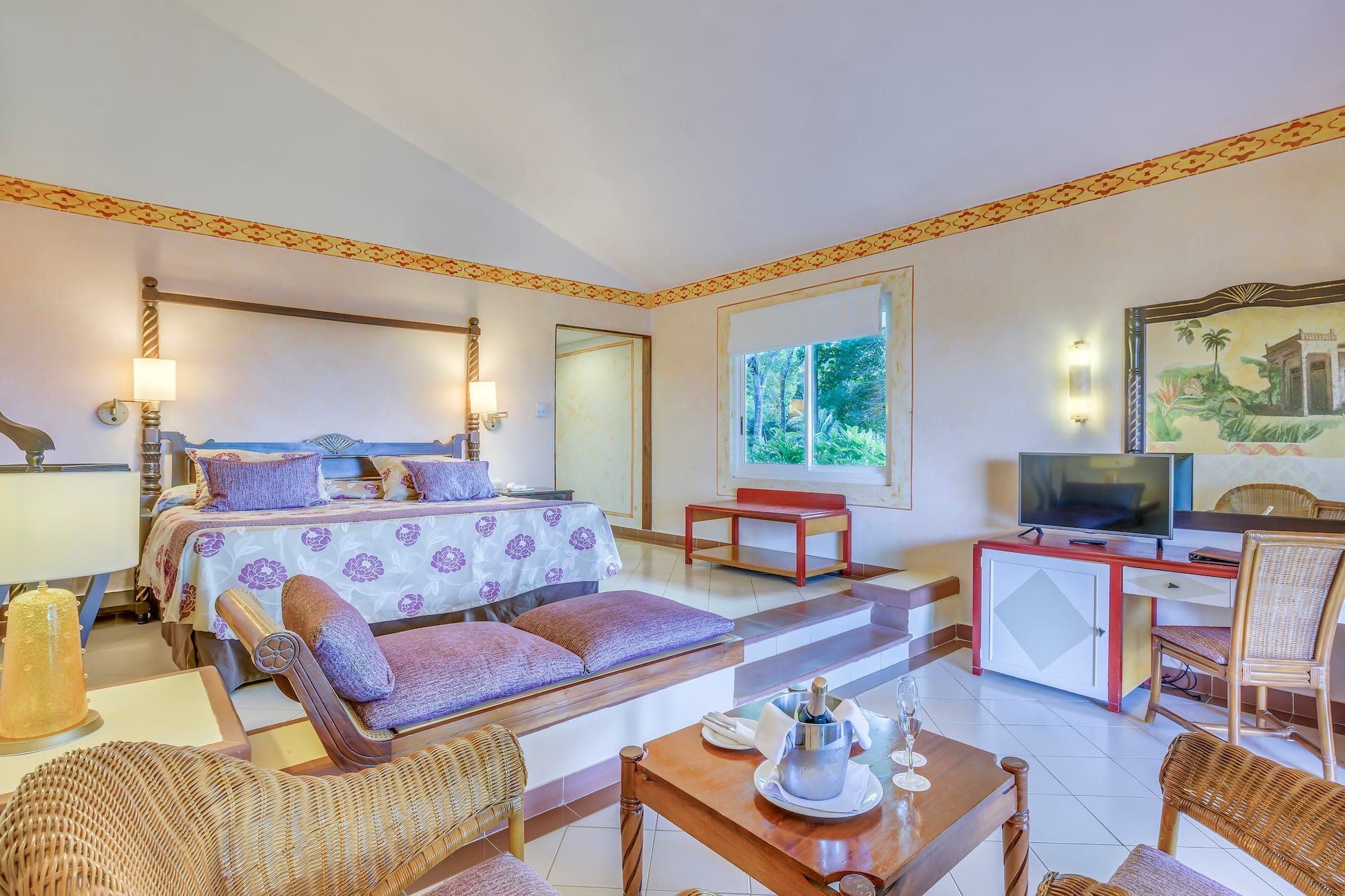 a room with a bed and a television