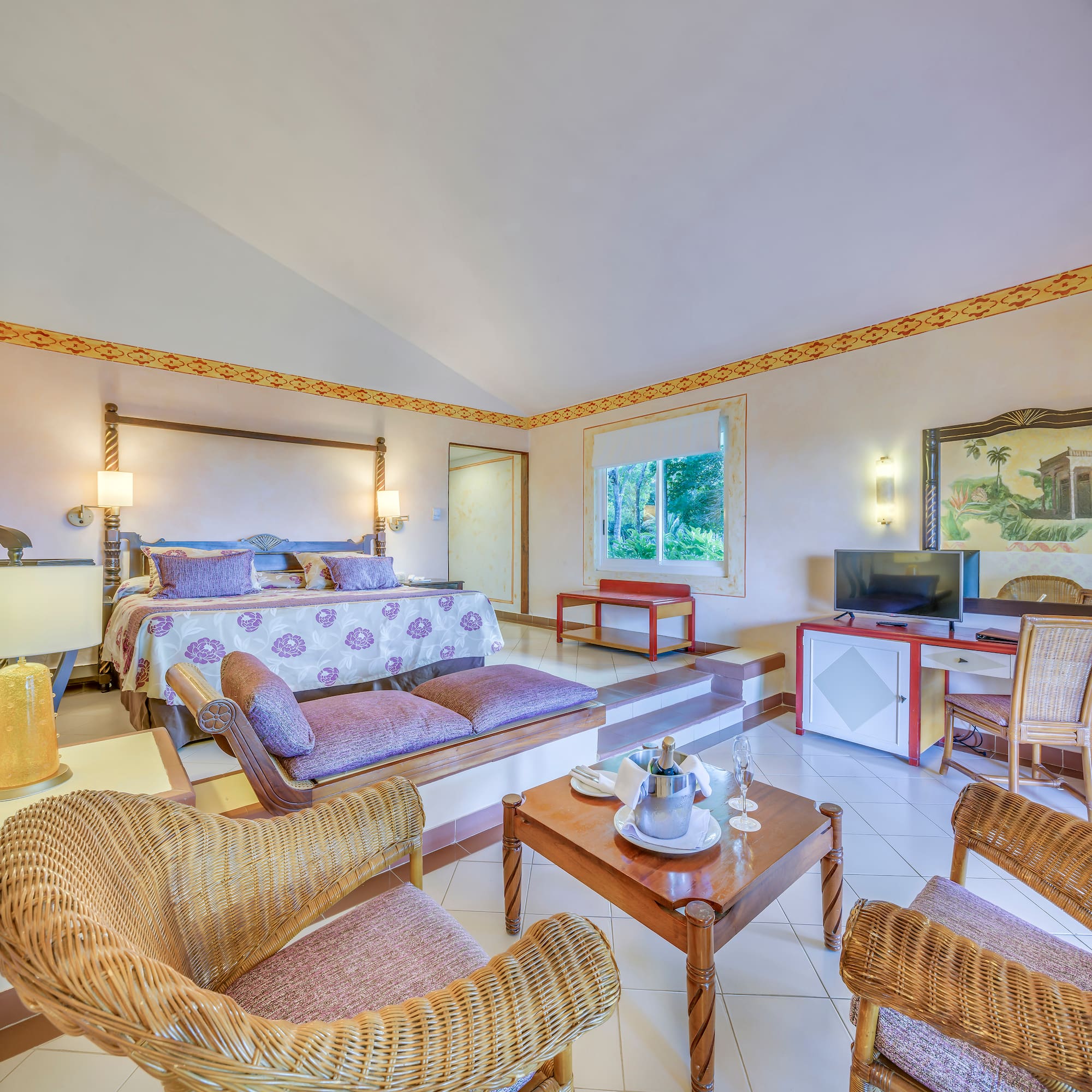 a room with a bed and a television