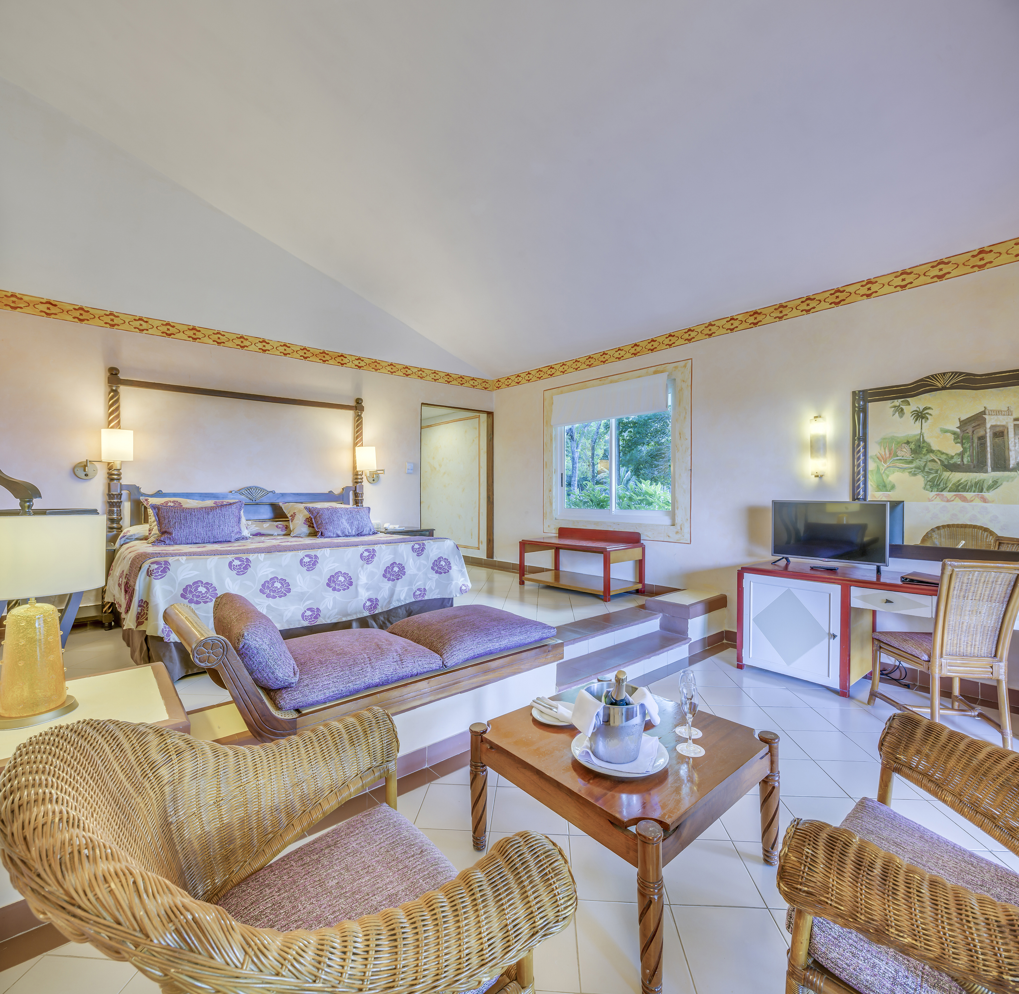 a room with a bed and a television