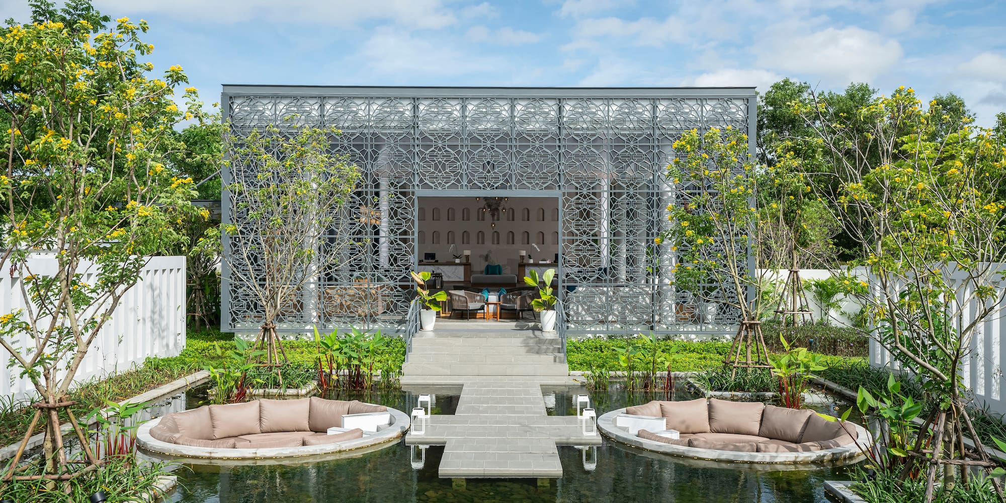 a pond with a patio and a patio with a pool and a patio with a patio and a deck with a table and chairs