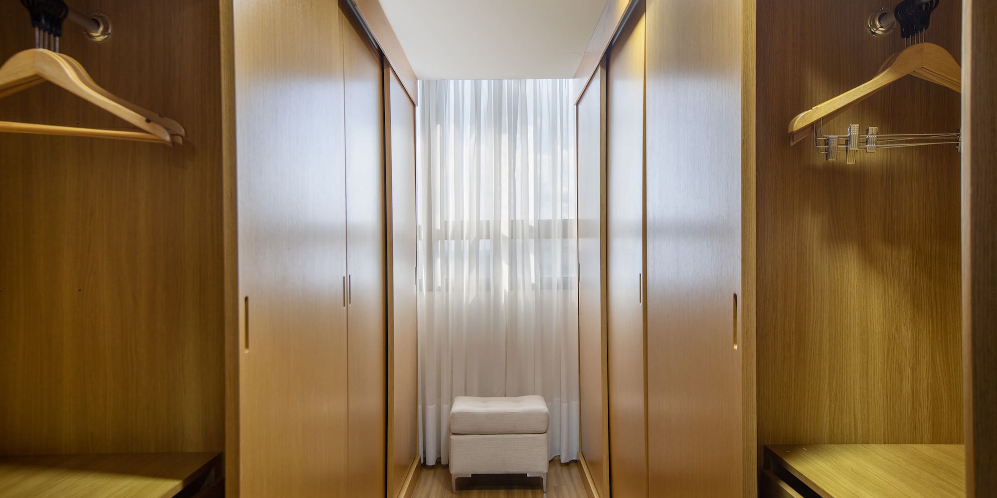 a room with wooden cabinets and a white curtain