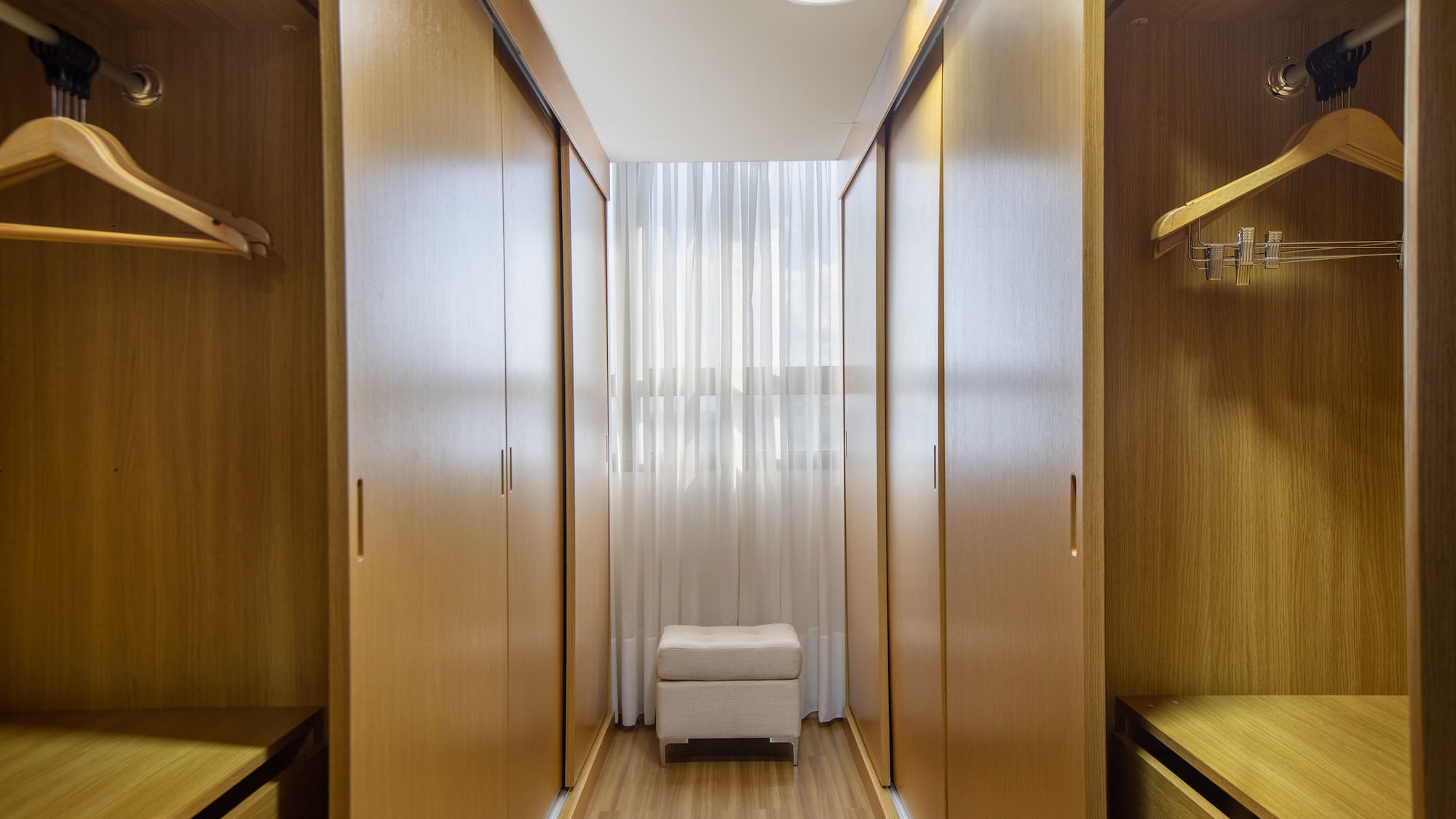 a room with wooden cabinets and a white curtain