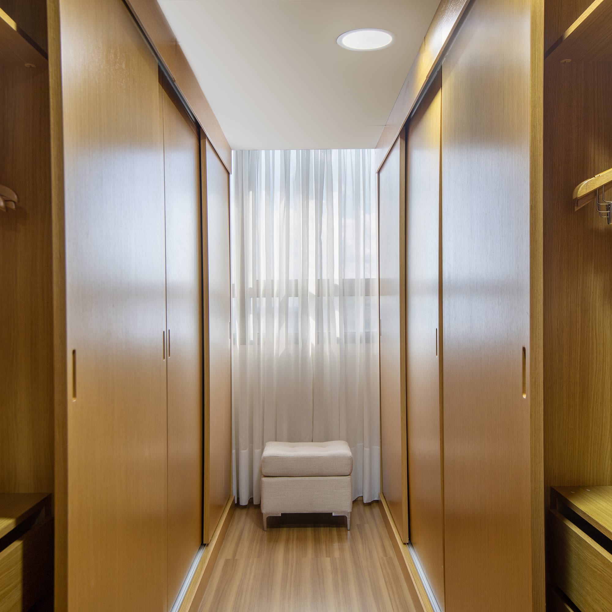 a room with wooden cabinets and a white curtain