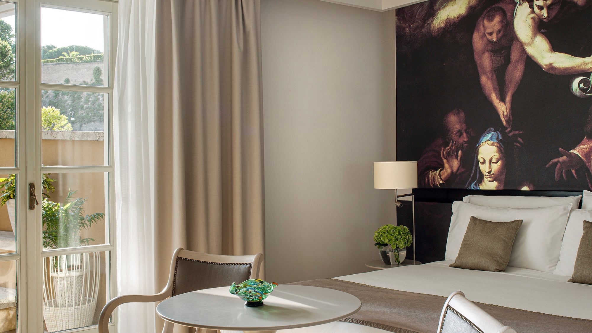 a room with a bed and chairs