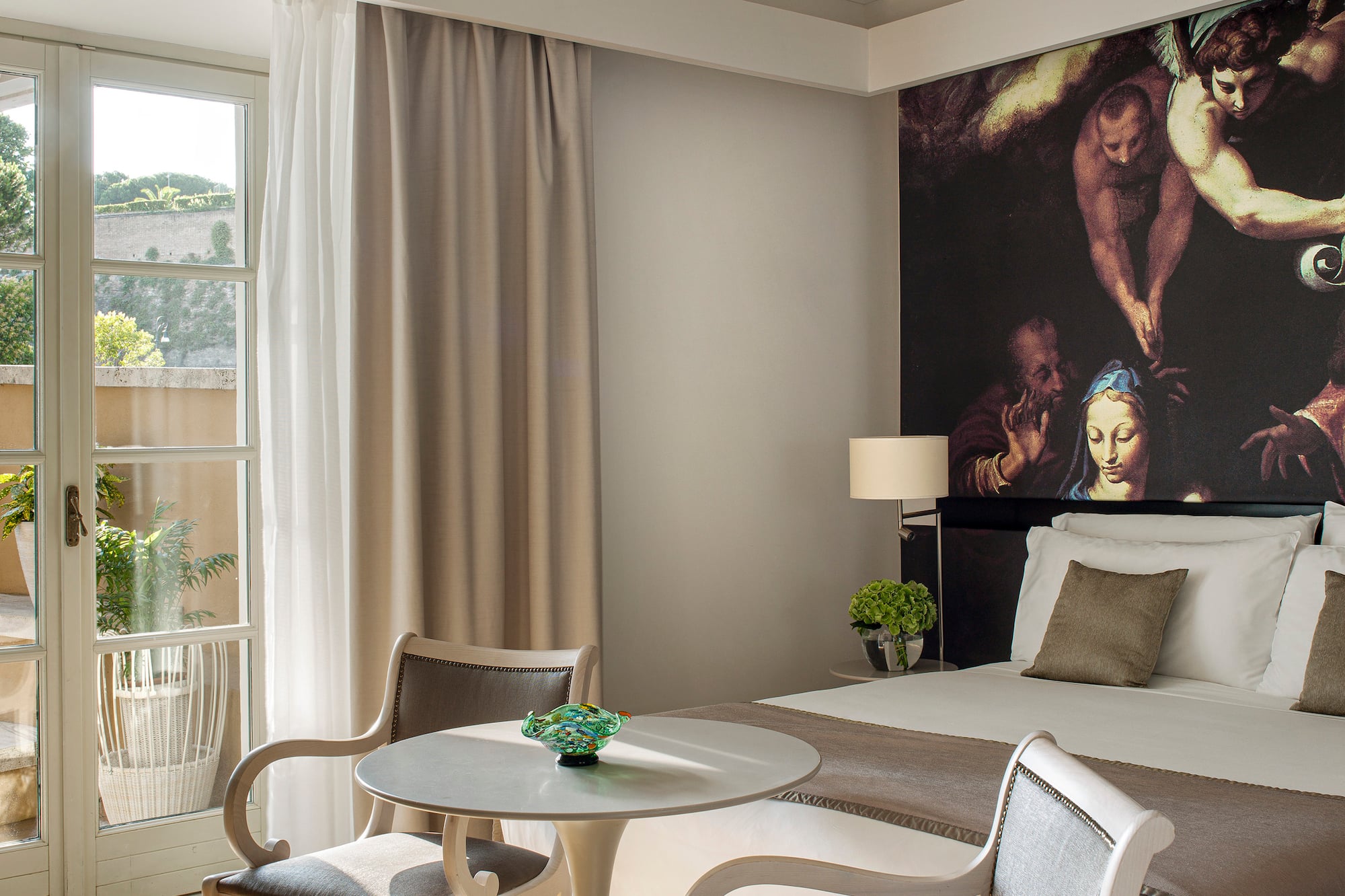 a room with a bed and chairs