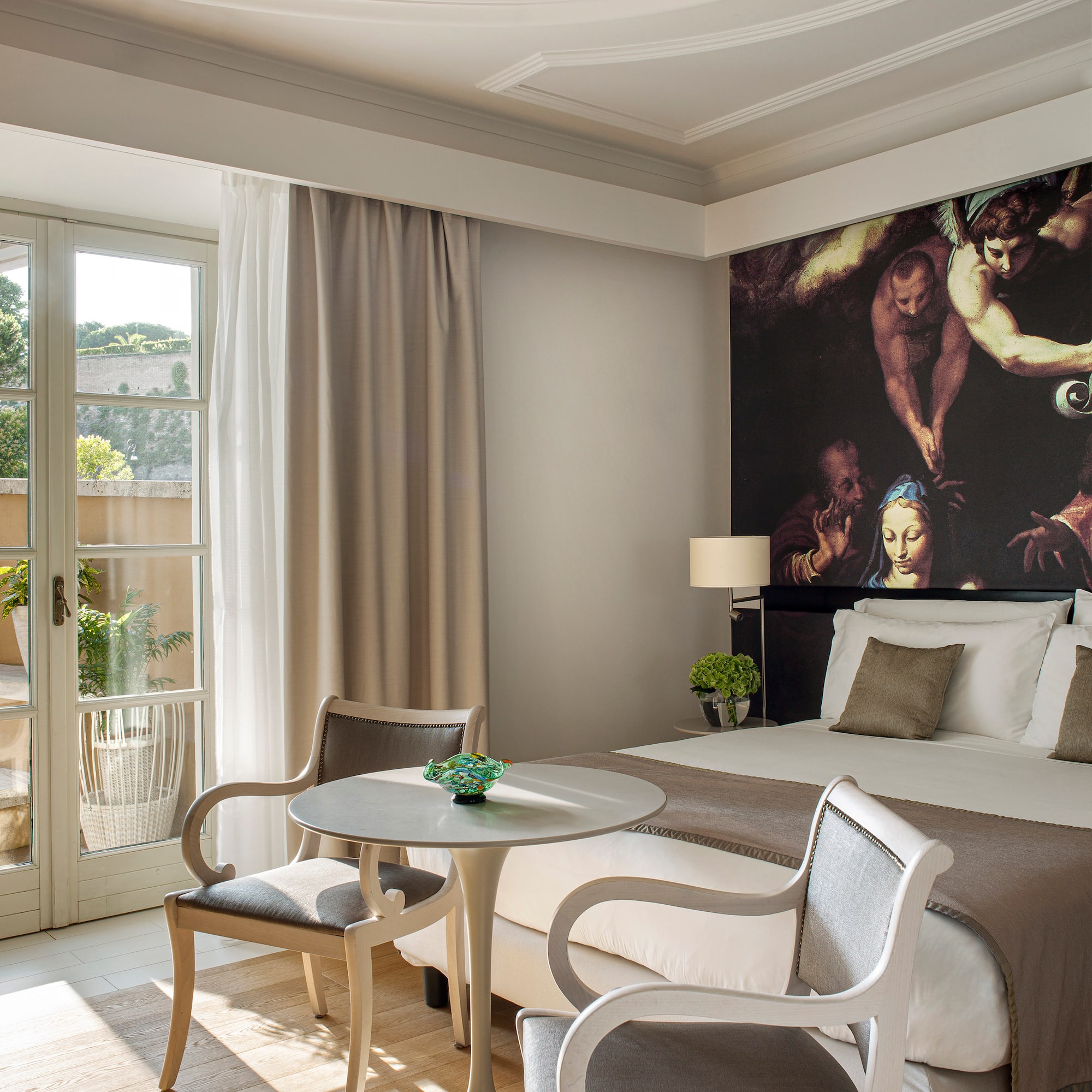 a room with a bed and chairs