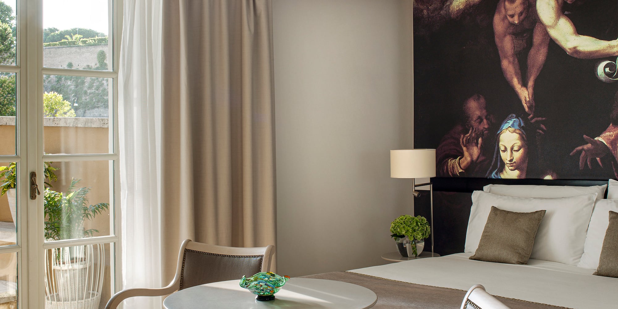 a room with a bed and chairs