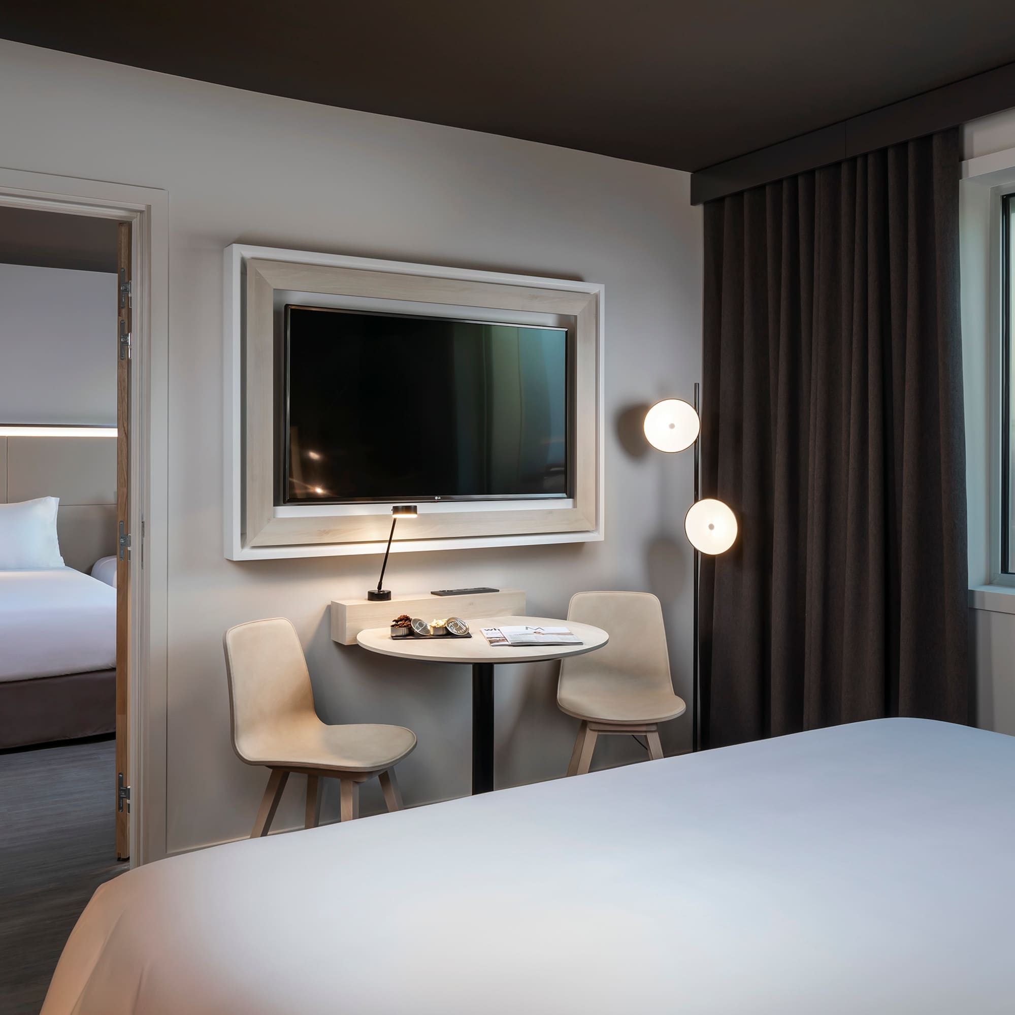 a room with a bed and a table and chairs