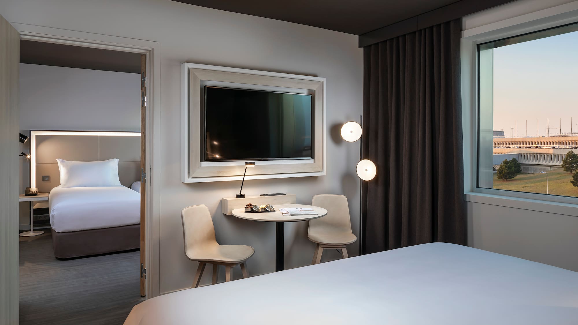 a room with a bed and a table and chairs