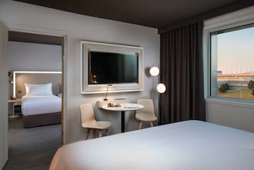 a room with a bed and a table and chairs