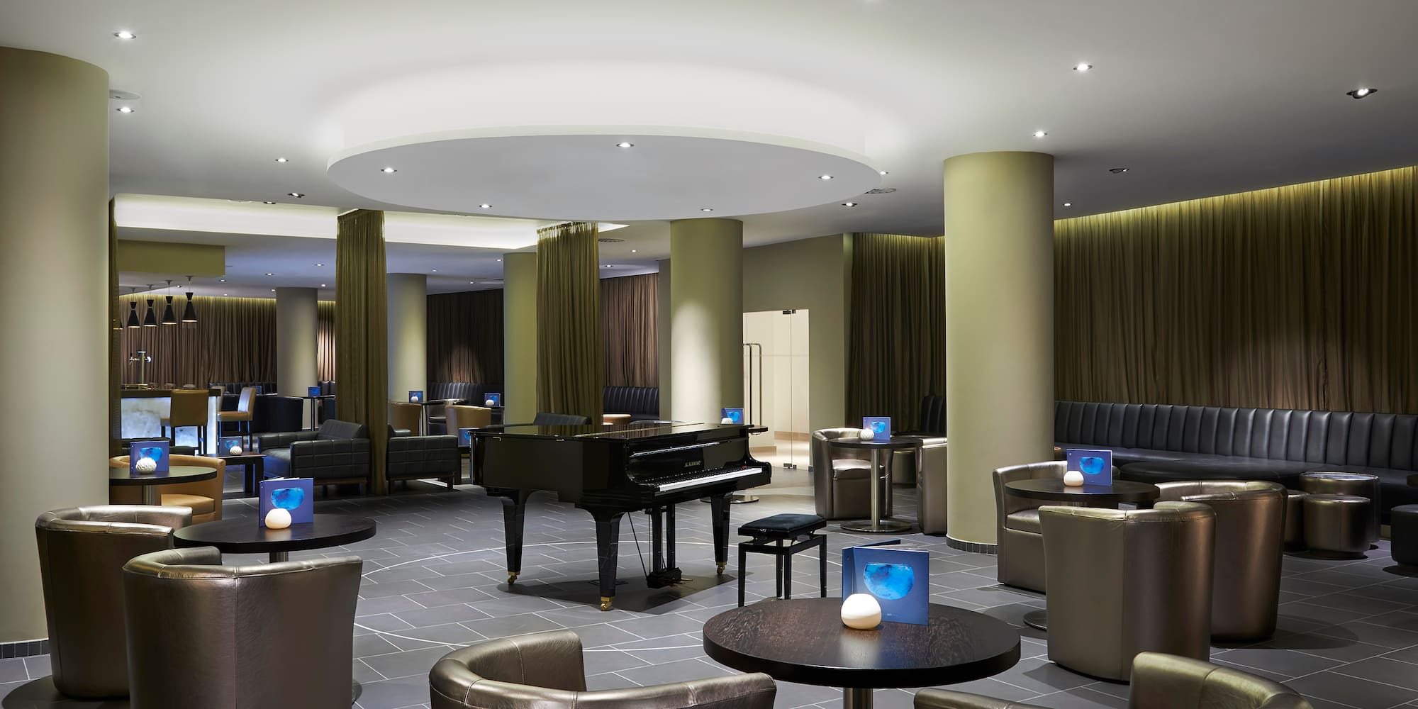 a room with a piano and chairs