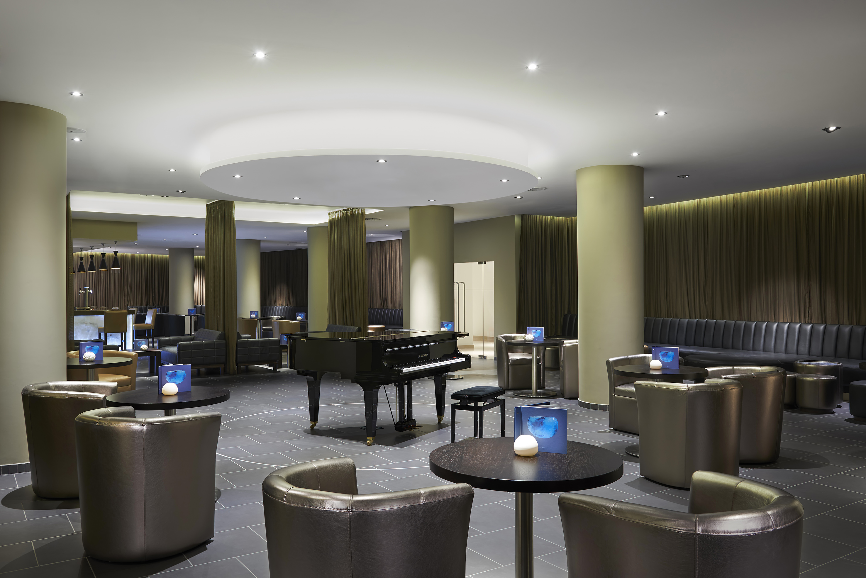 a room with a piano and chairs