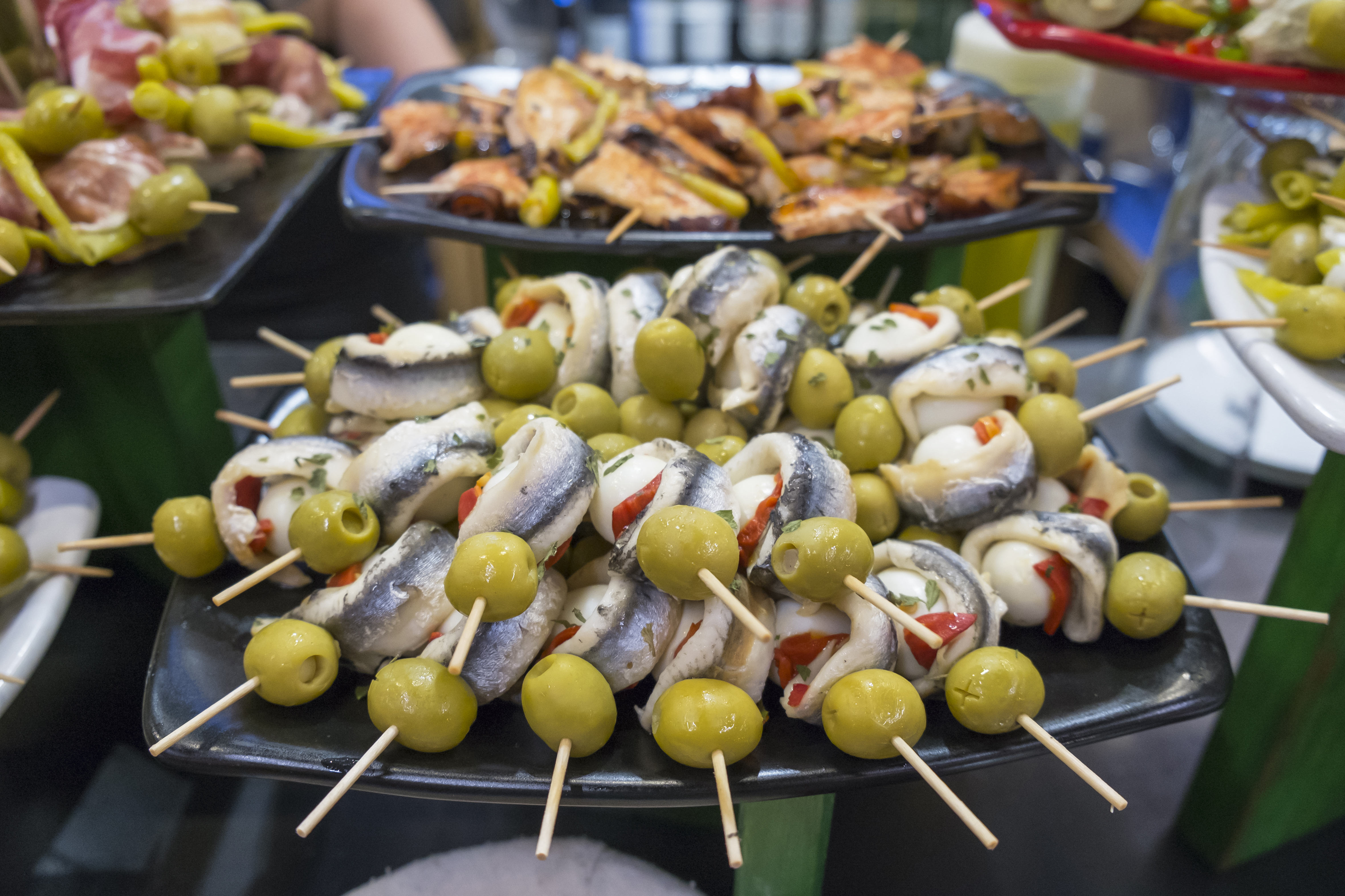 Spanish Gilda pintxos: anchovies, green olives, and red peppers on skewers.