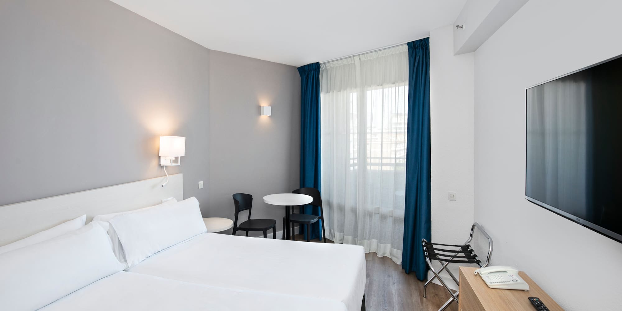 a room with two beds and a table