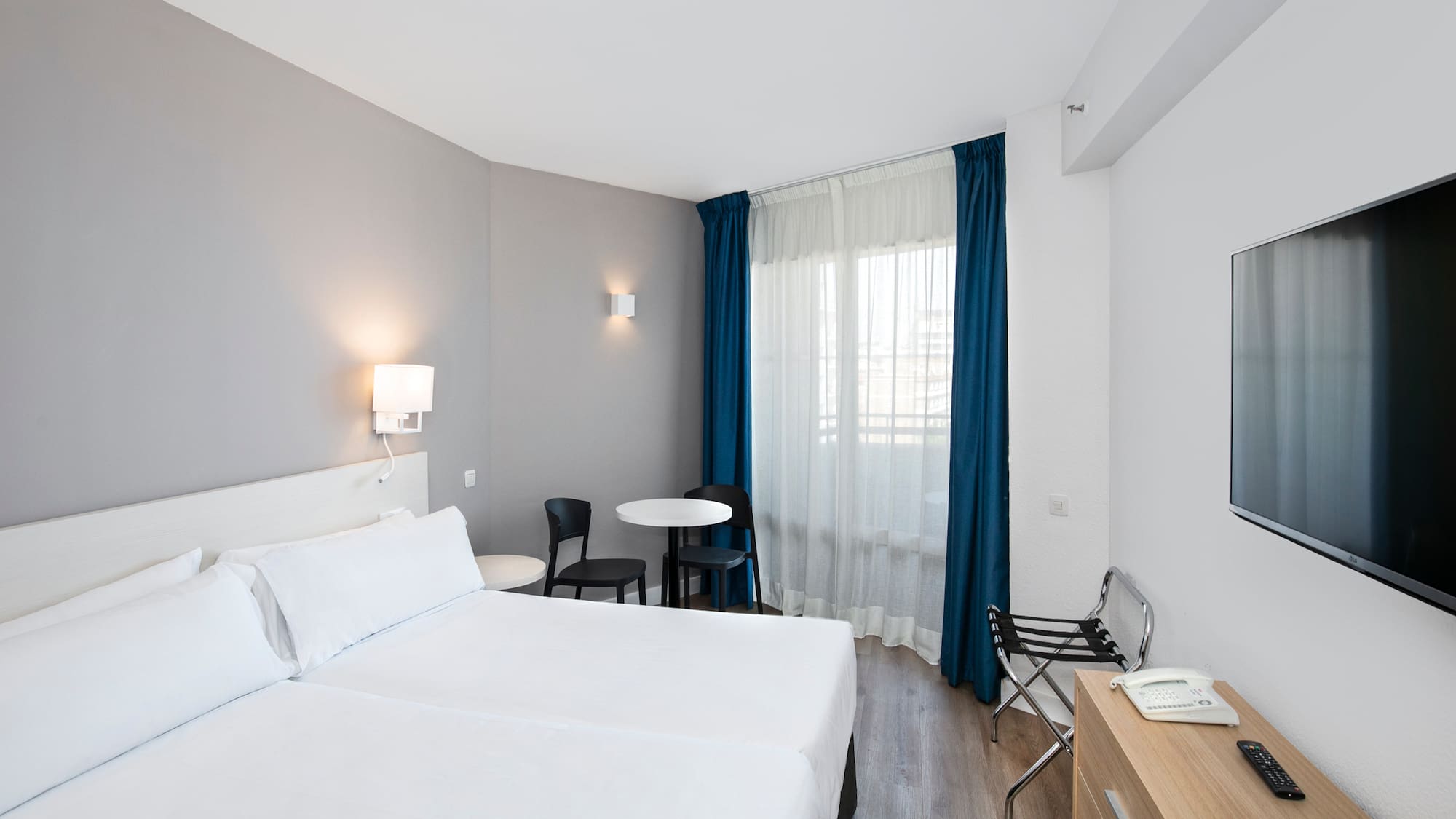 a room with two beds and a table