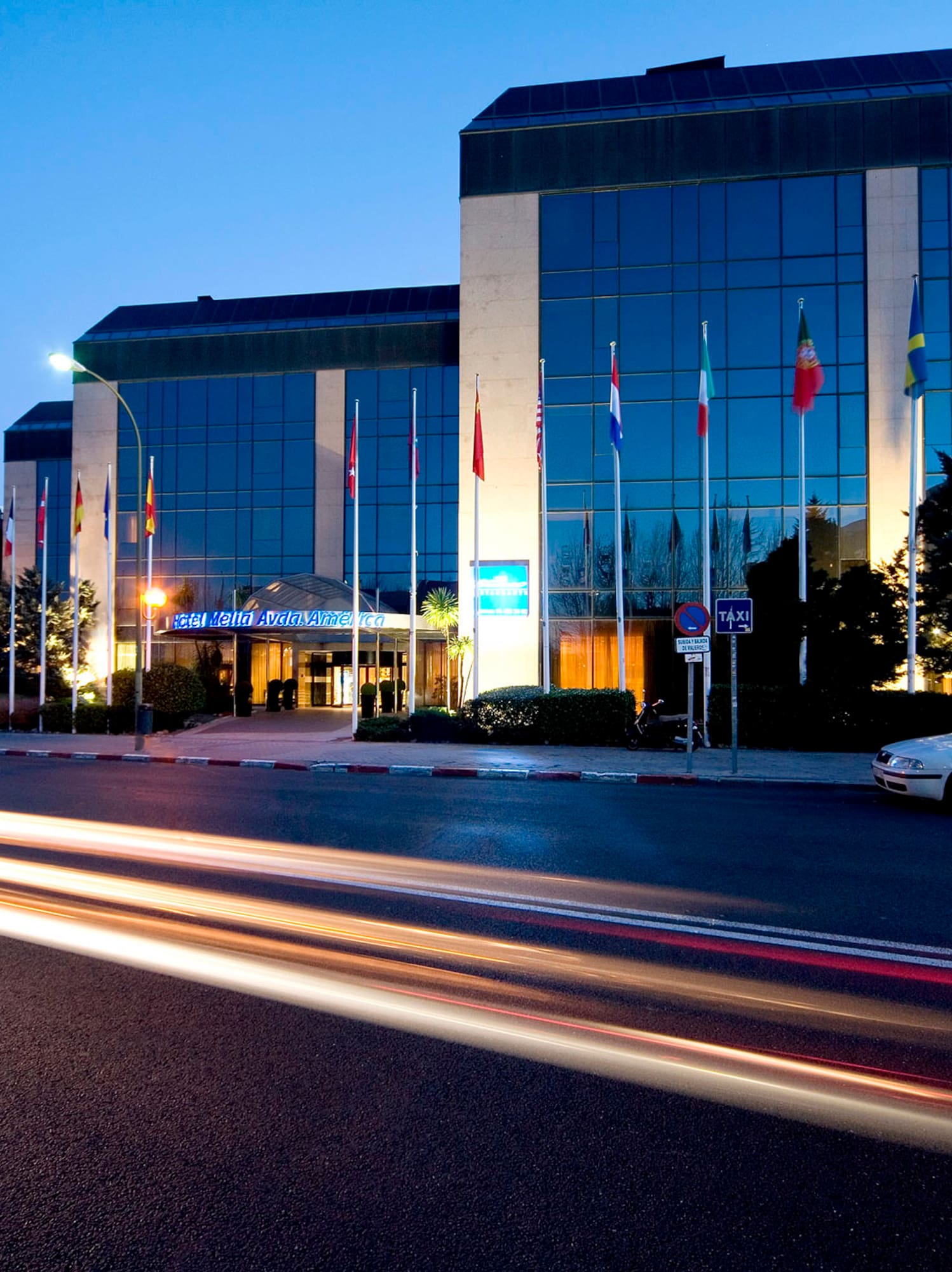 a car driving on a road next to a building