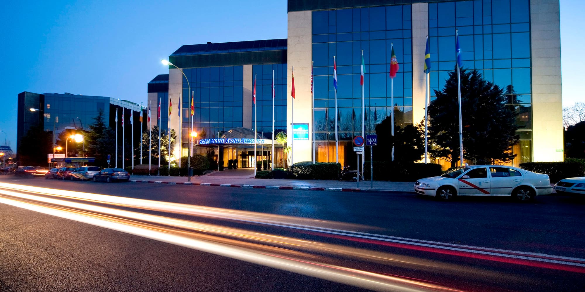 a car driving on a road next to a building