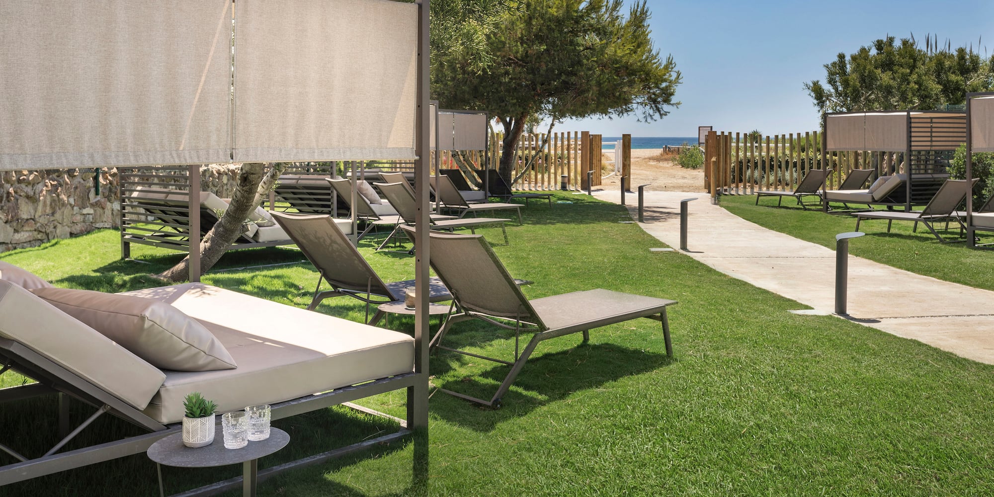 a lawn chairs and a walkway on a sunny day