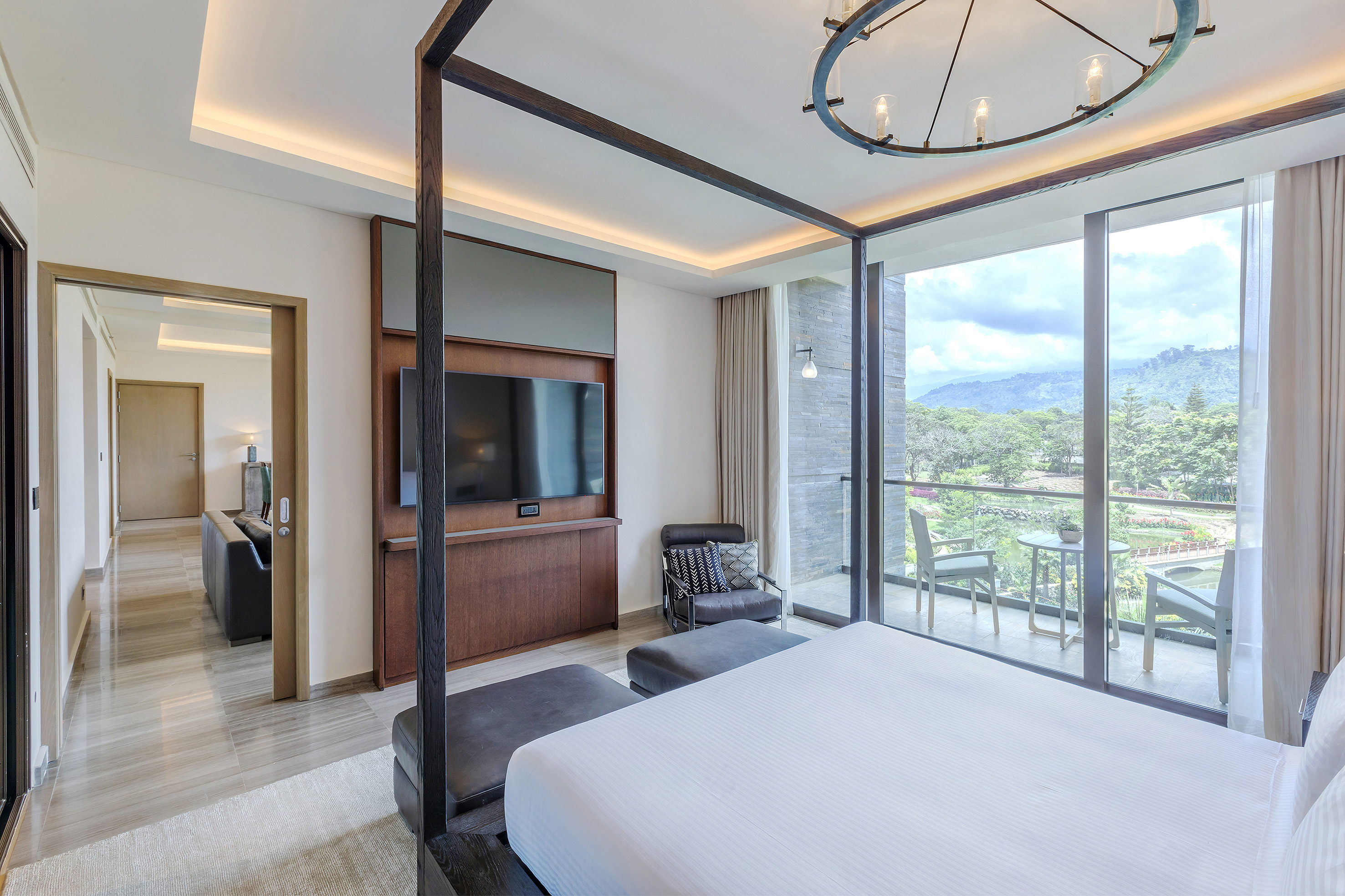 a bedroom with a bed and a television