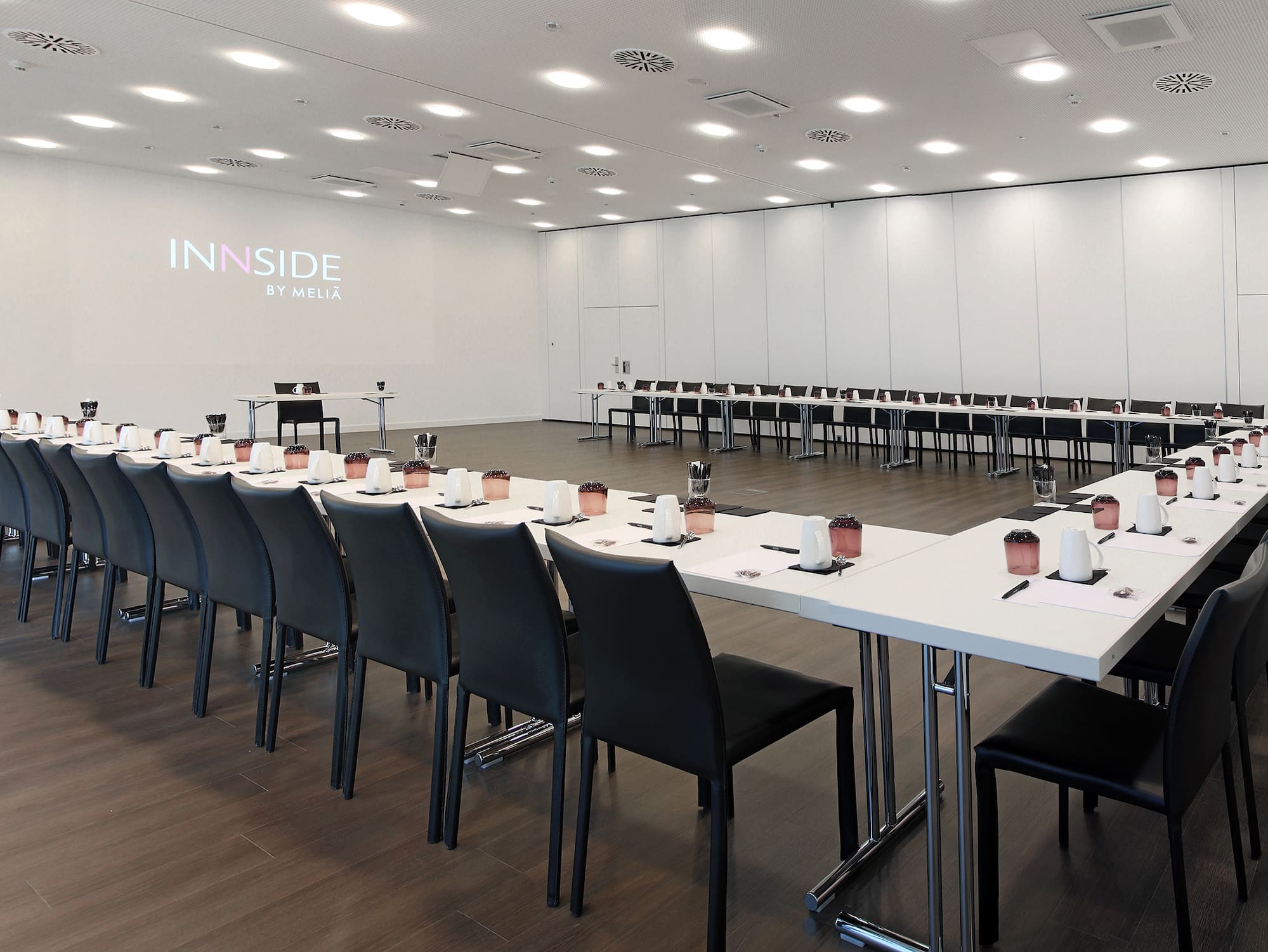 a room with white tables and chairs