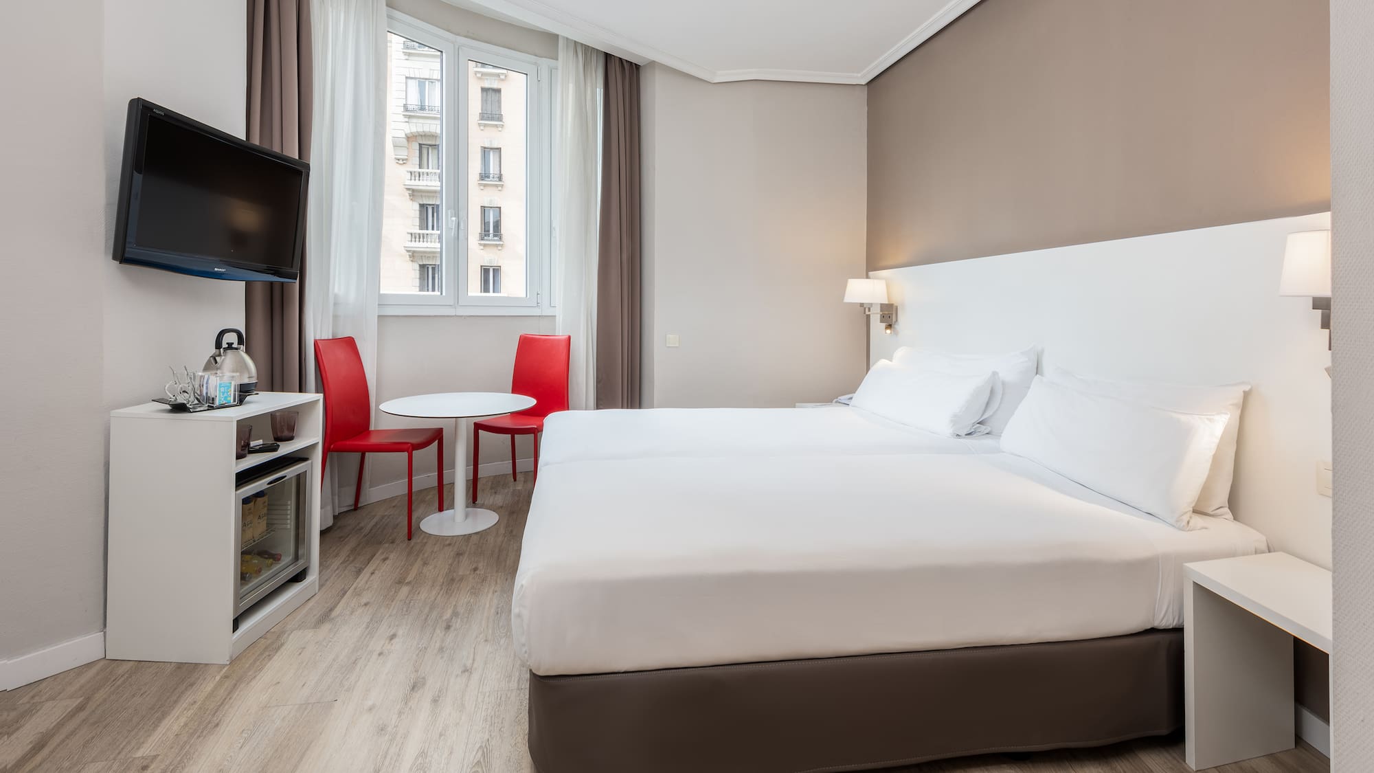 a room with two beds and a tv