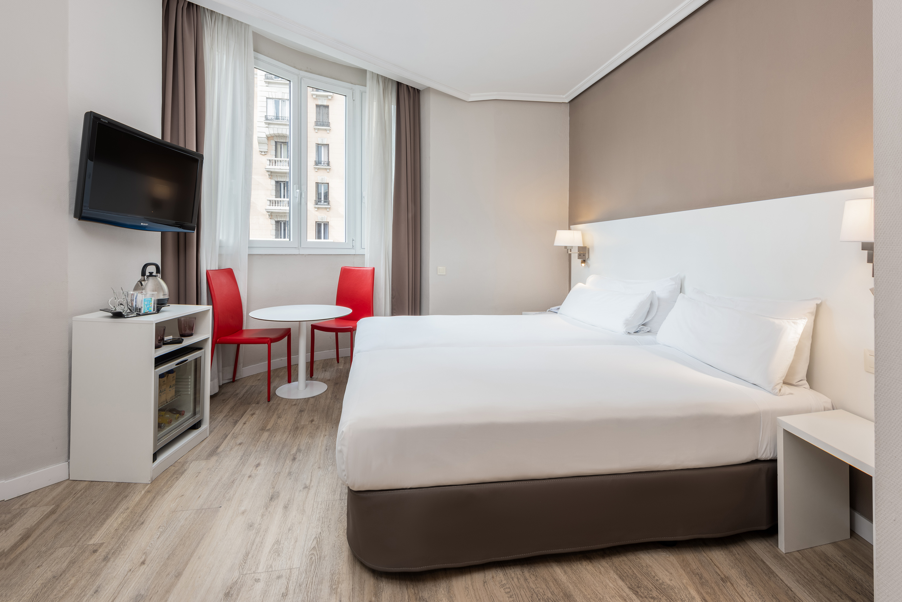 a room with two beds and a tv