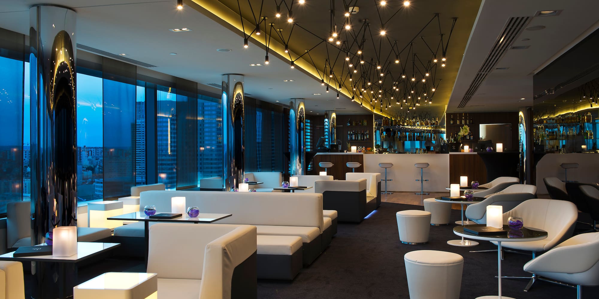 a room with white couches and tables