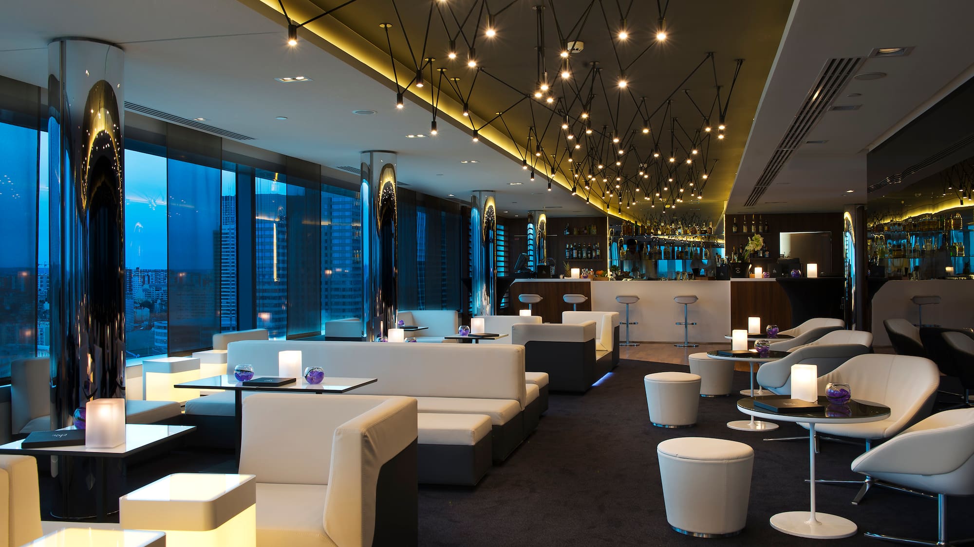 a room with white couches and tables