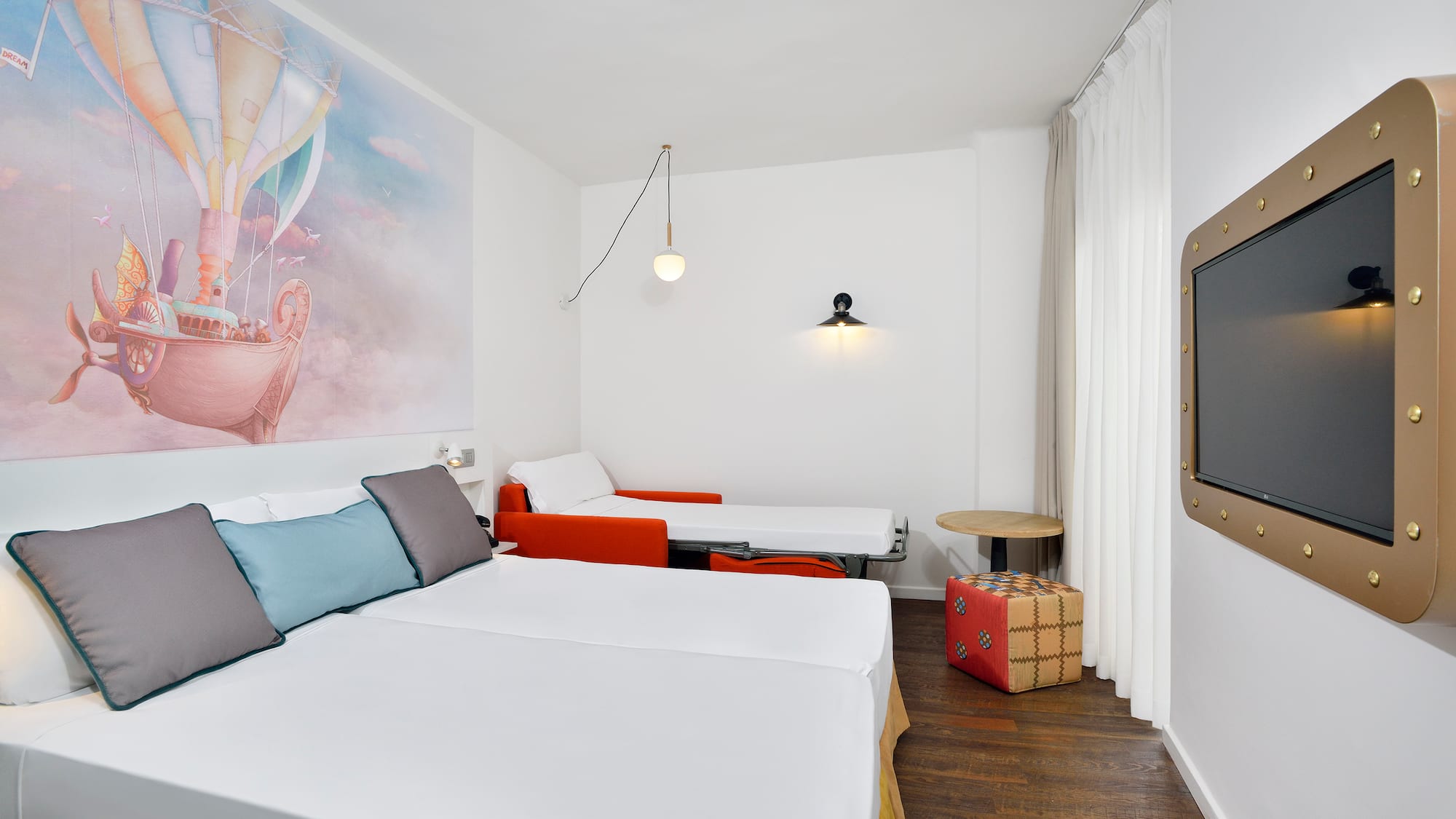 a room with two beds and a table