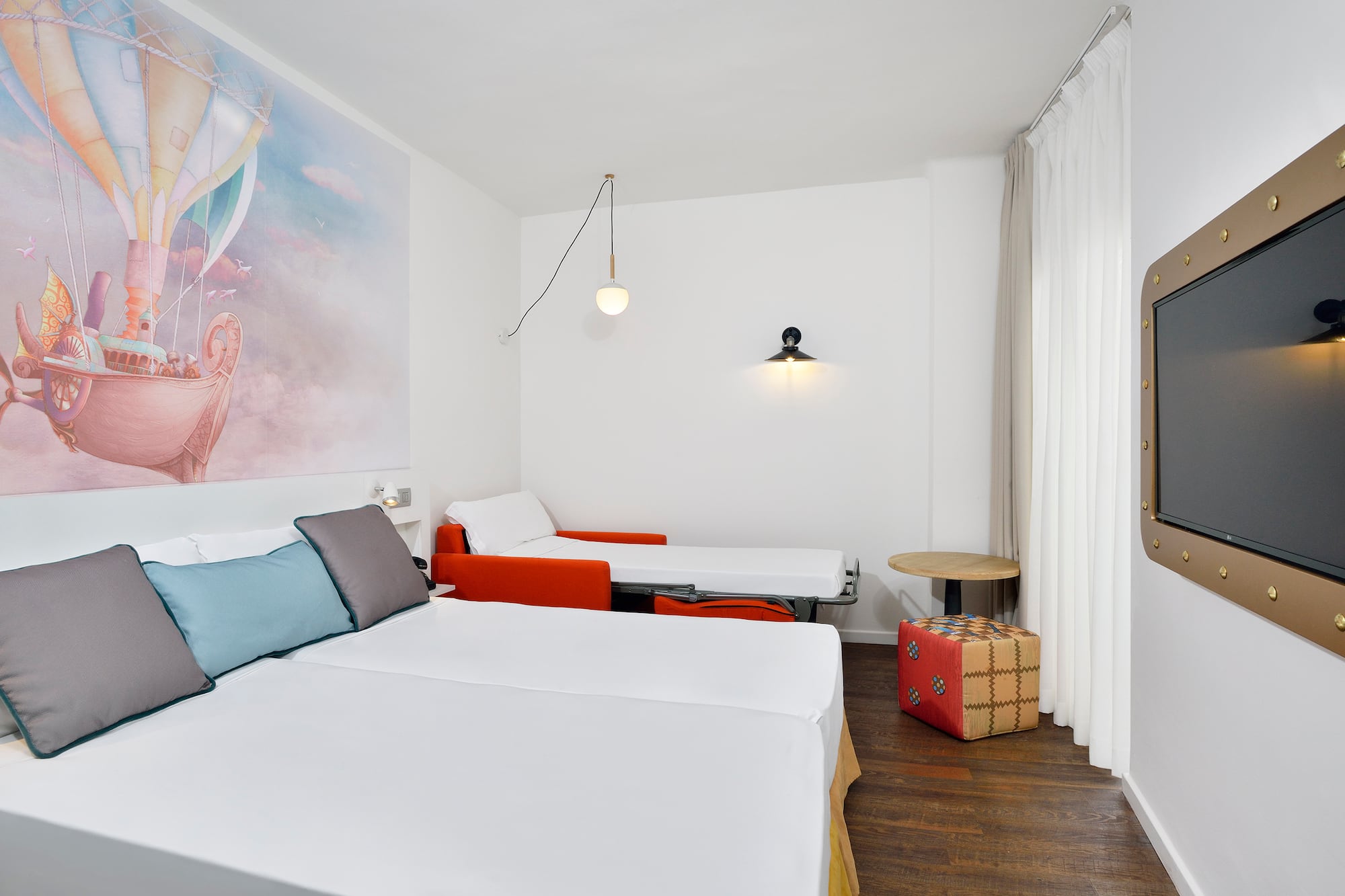 a room with two beds and a table