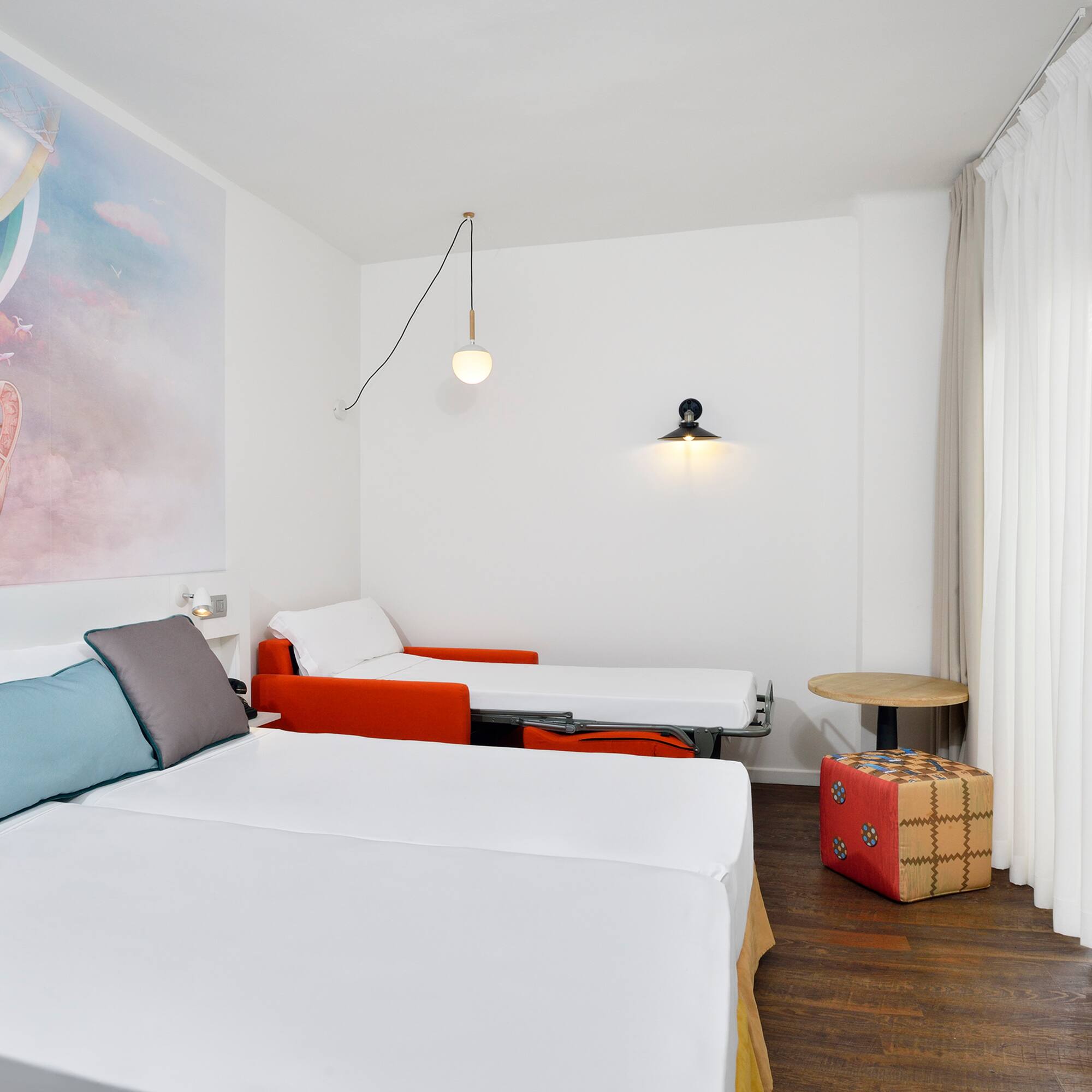 a room with two beds and a table