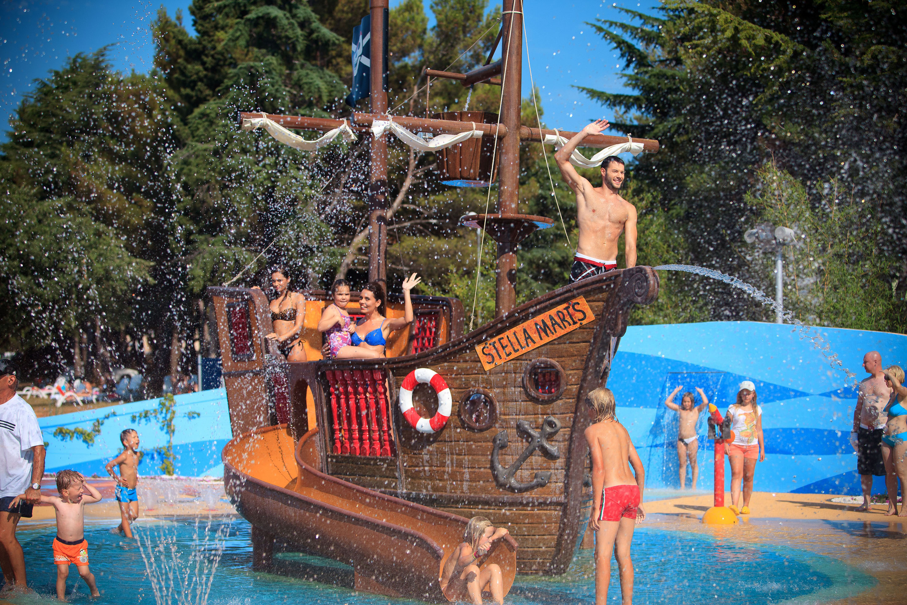 a group of people on a ship in a pool