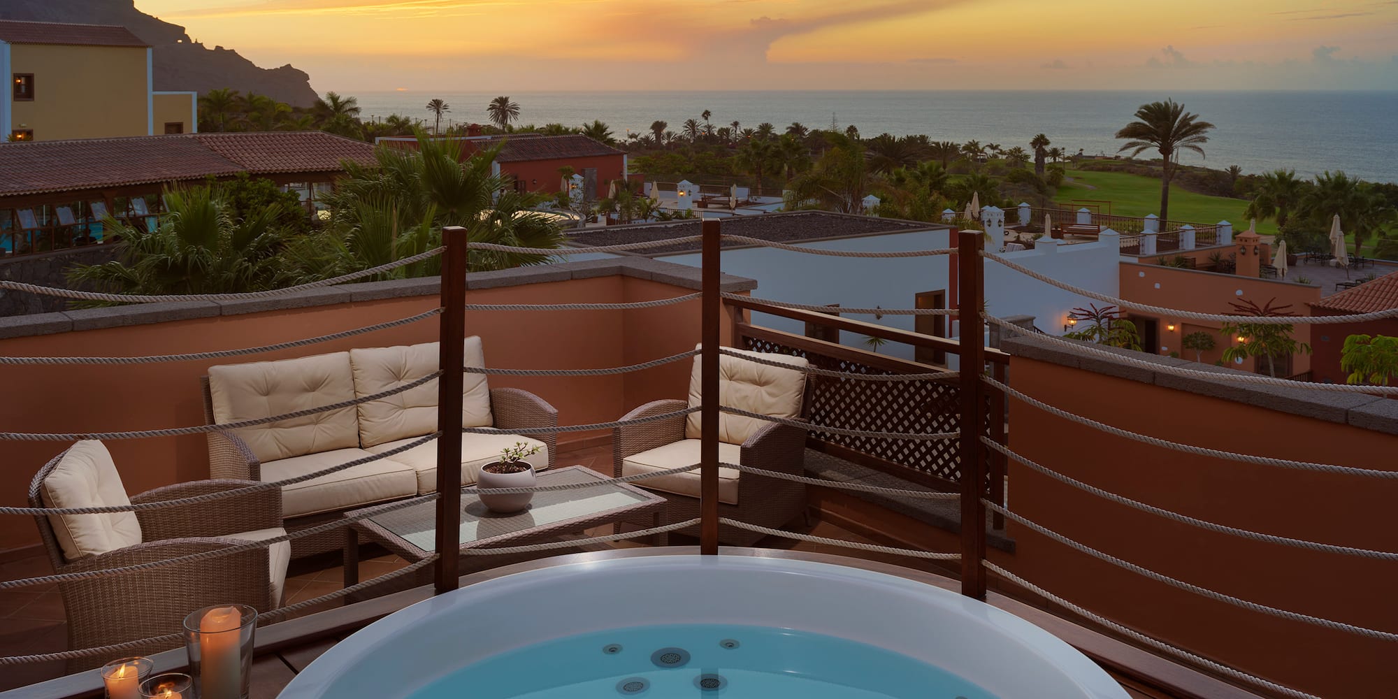 a hot tub on a deck overlooking a body of water
