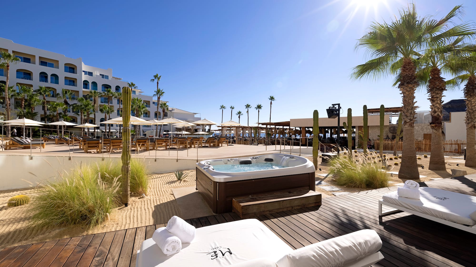 a hot tub and lounge chairs on a deck