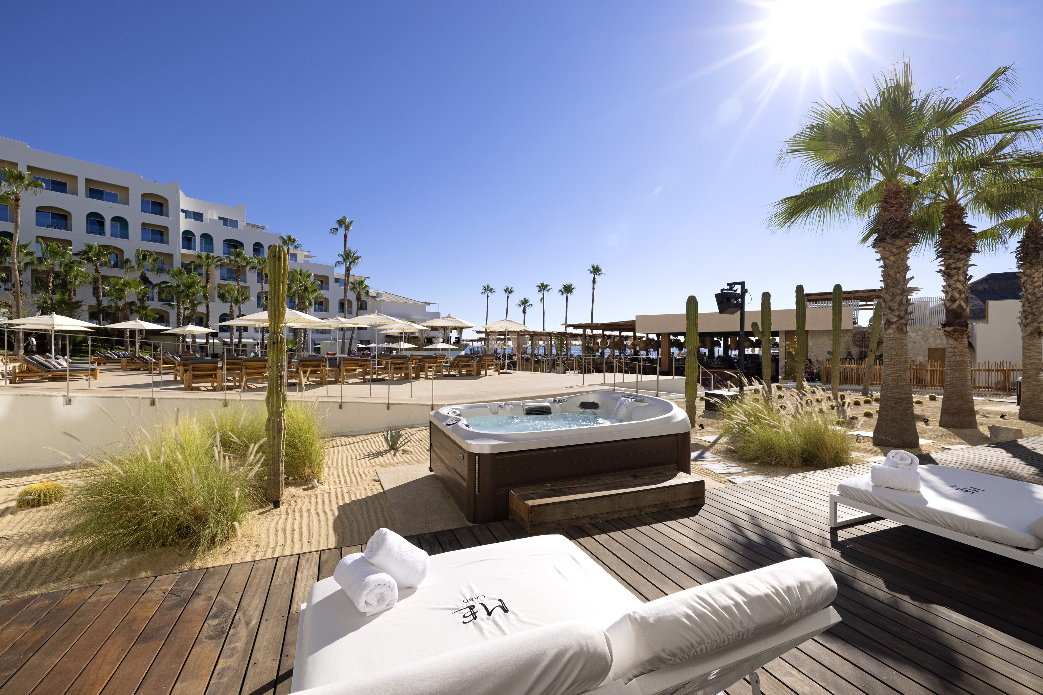 a hot tub and lounge chairs on a deck