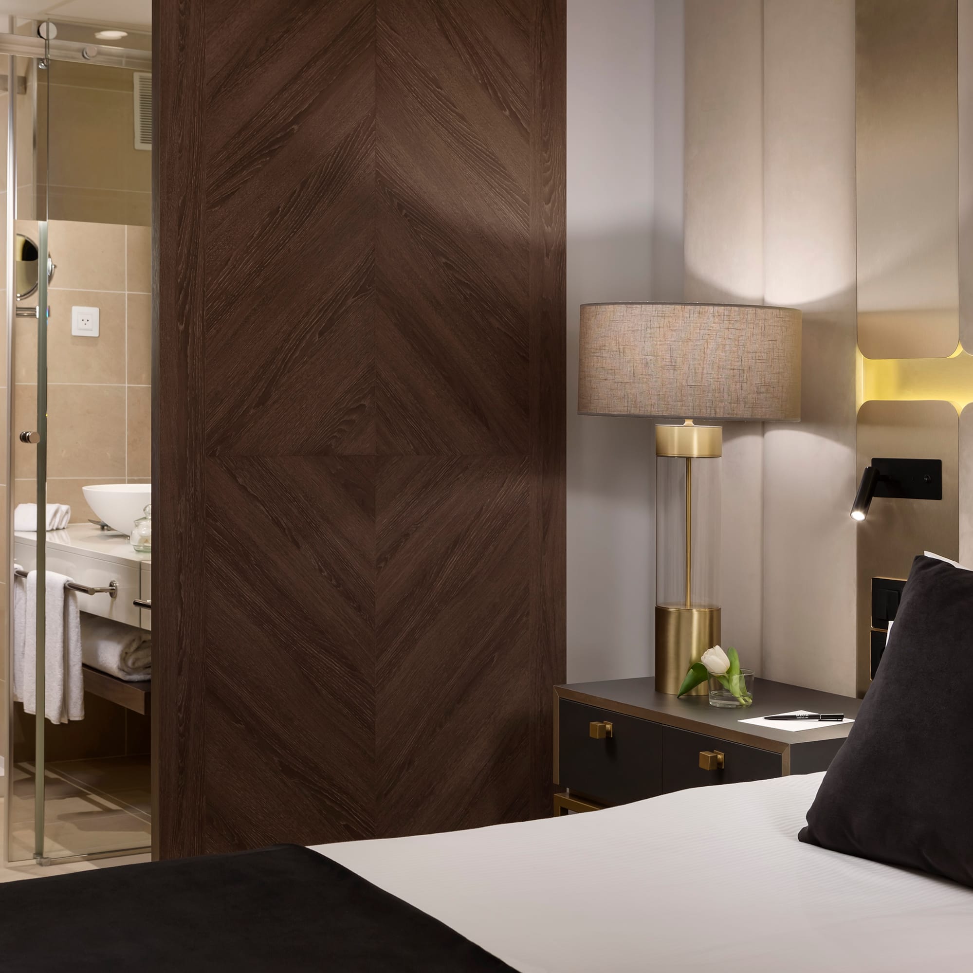 a bedroom with a glass door and a mirror