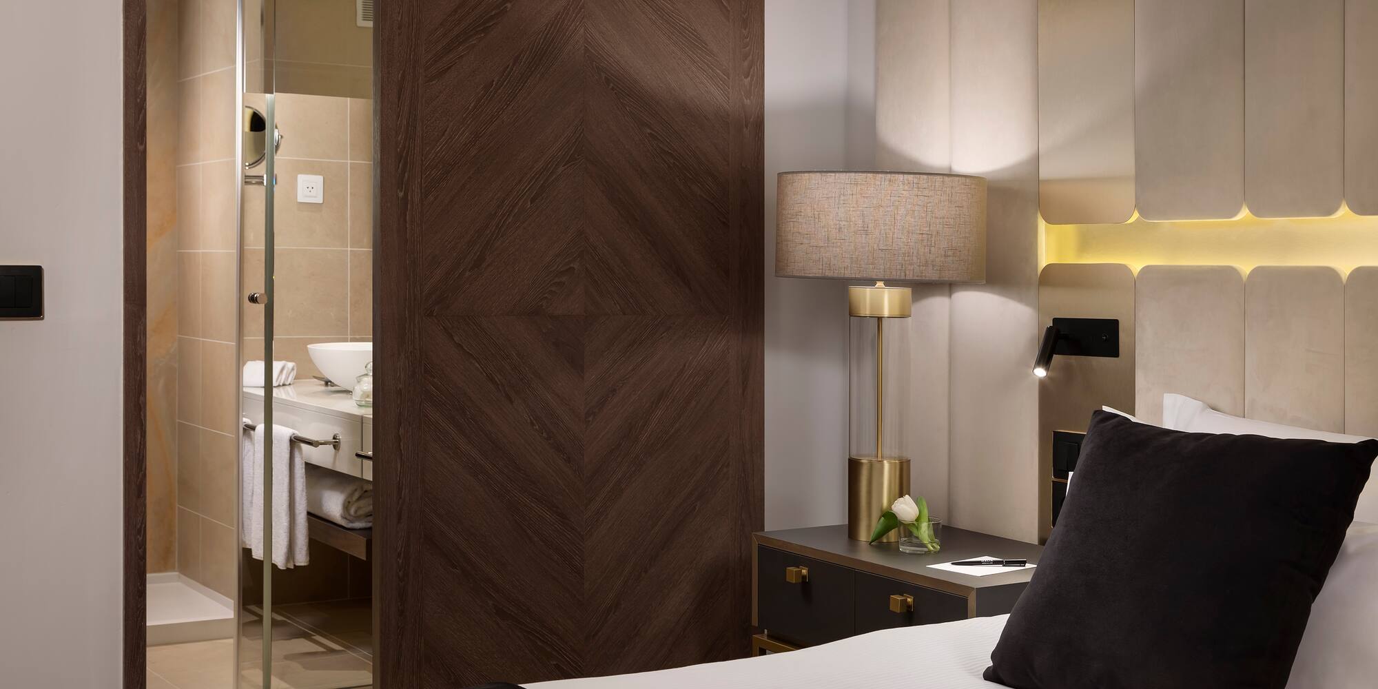 a bedroom with a glass door and a mirror