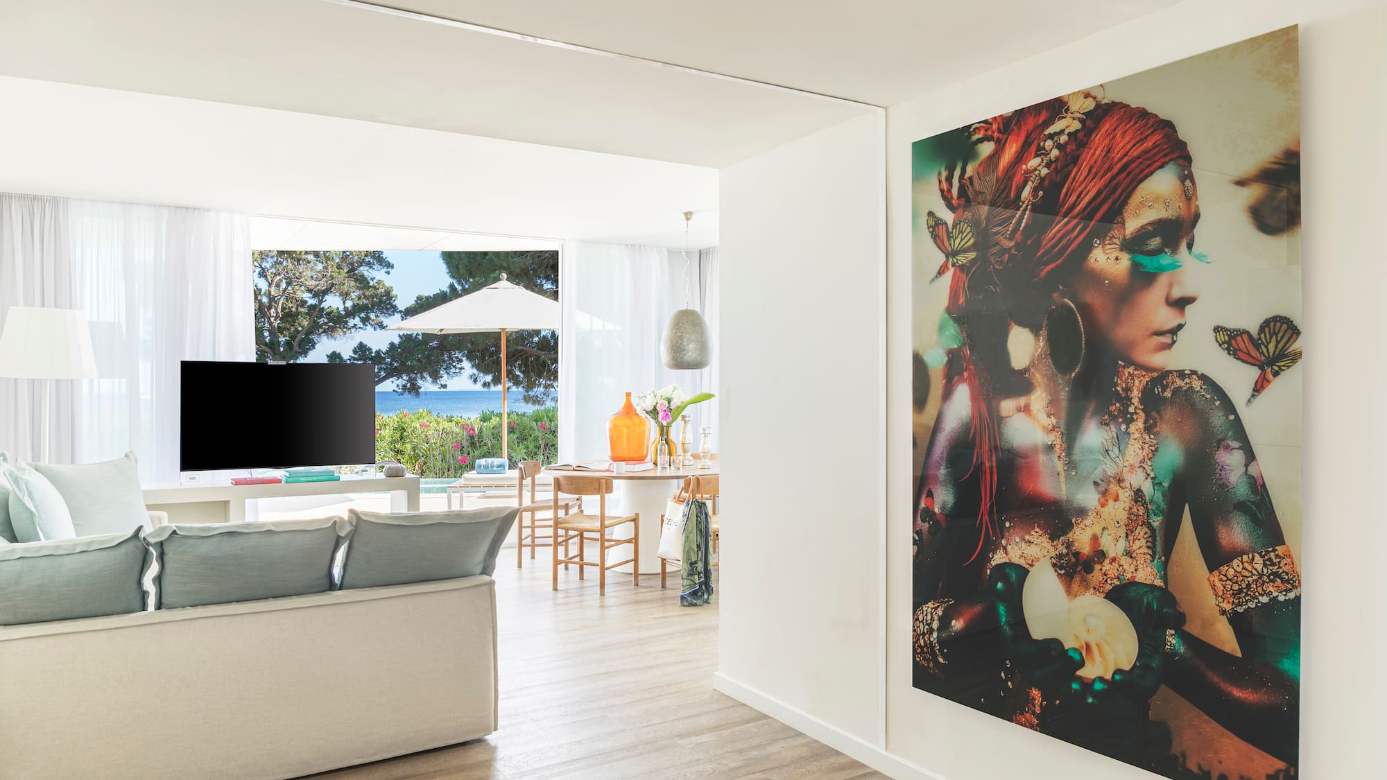 a living room with a large painting on the wall