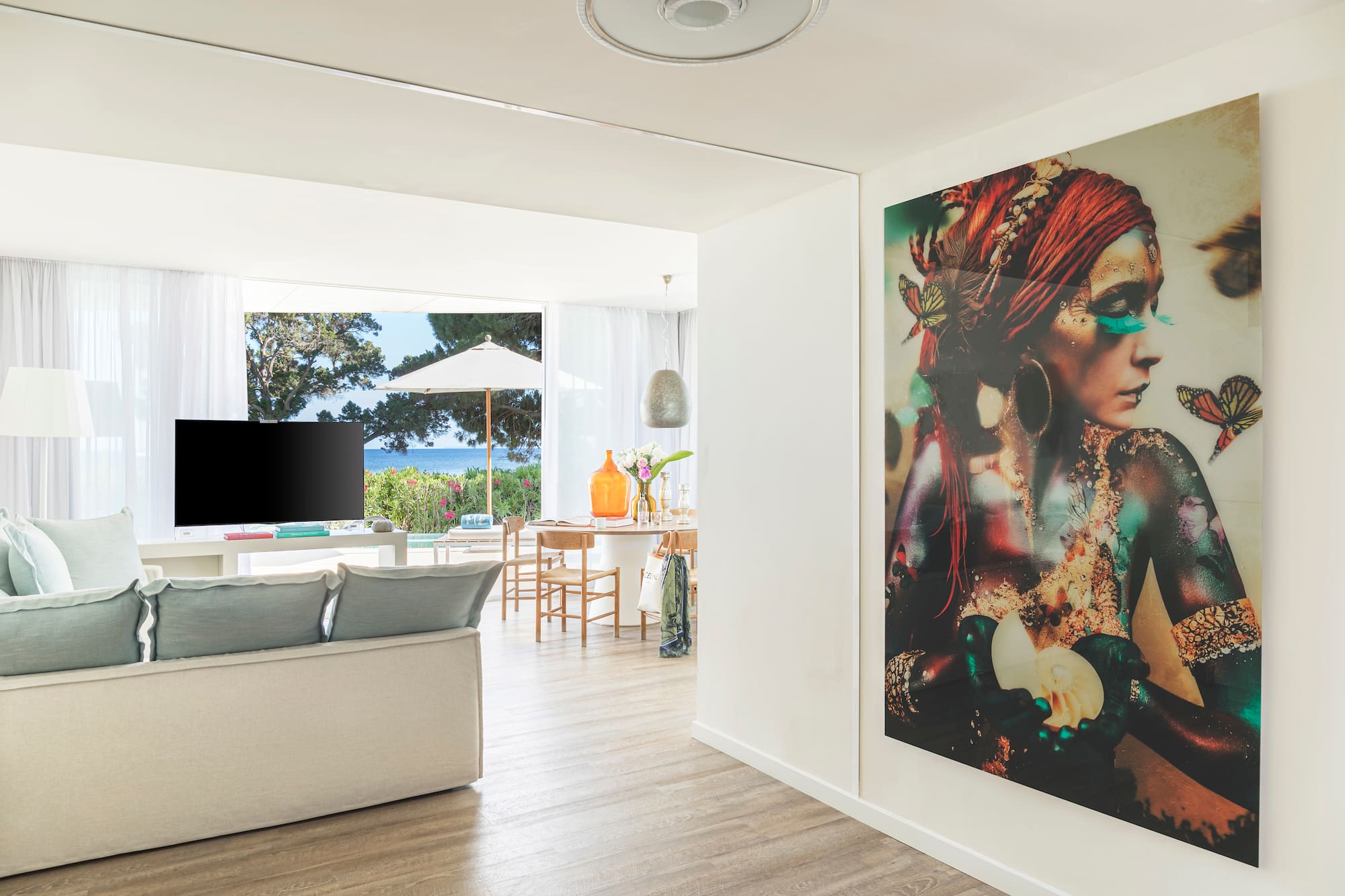 a living room with a large painting on the wall