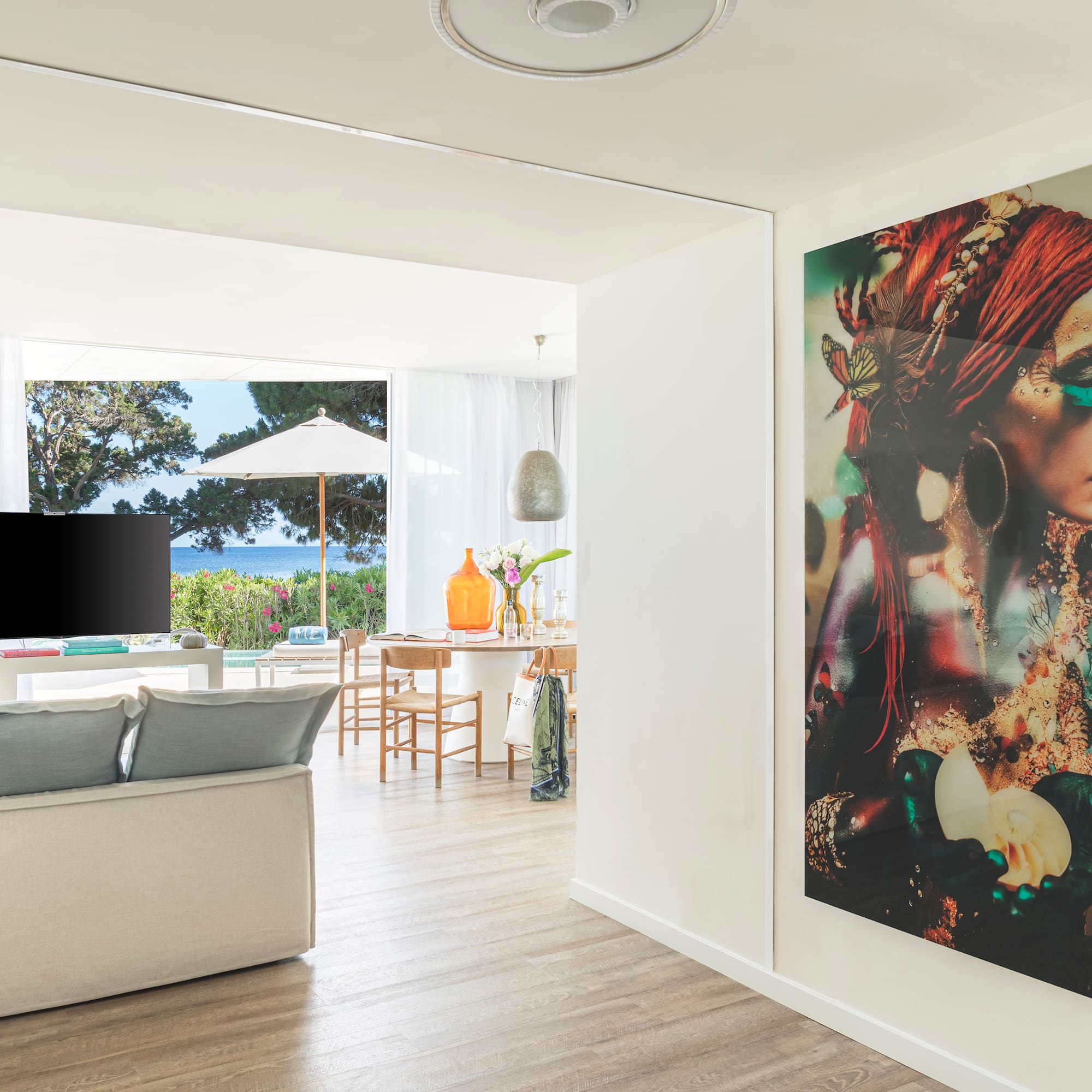 a living room with a large painting on the wall