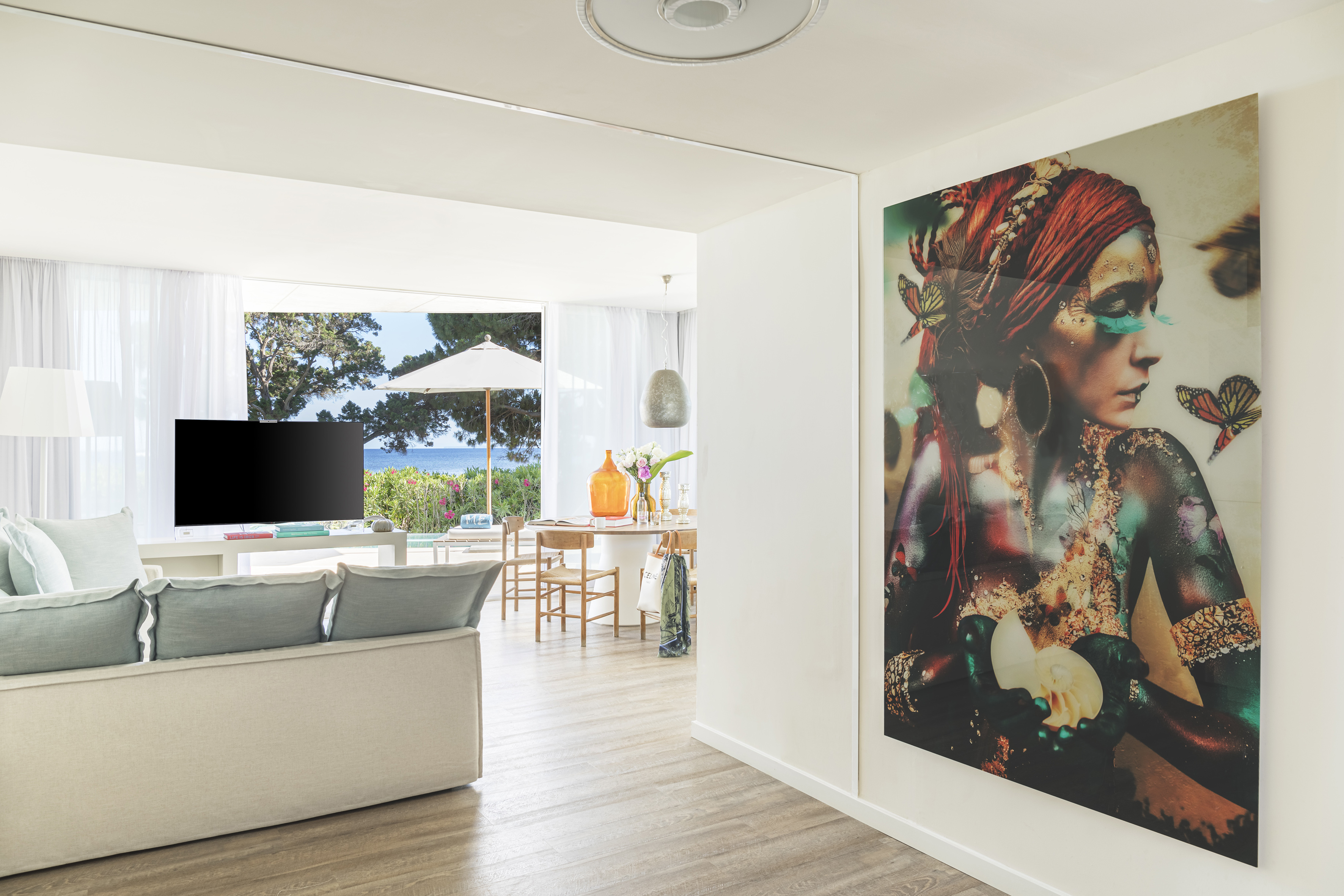 a living room with a large painting on the wall