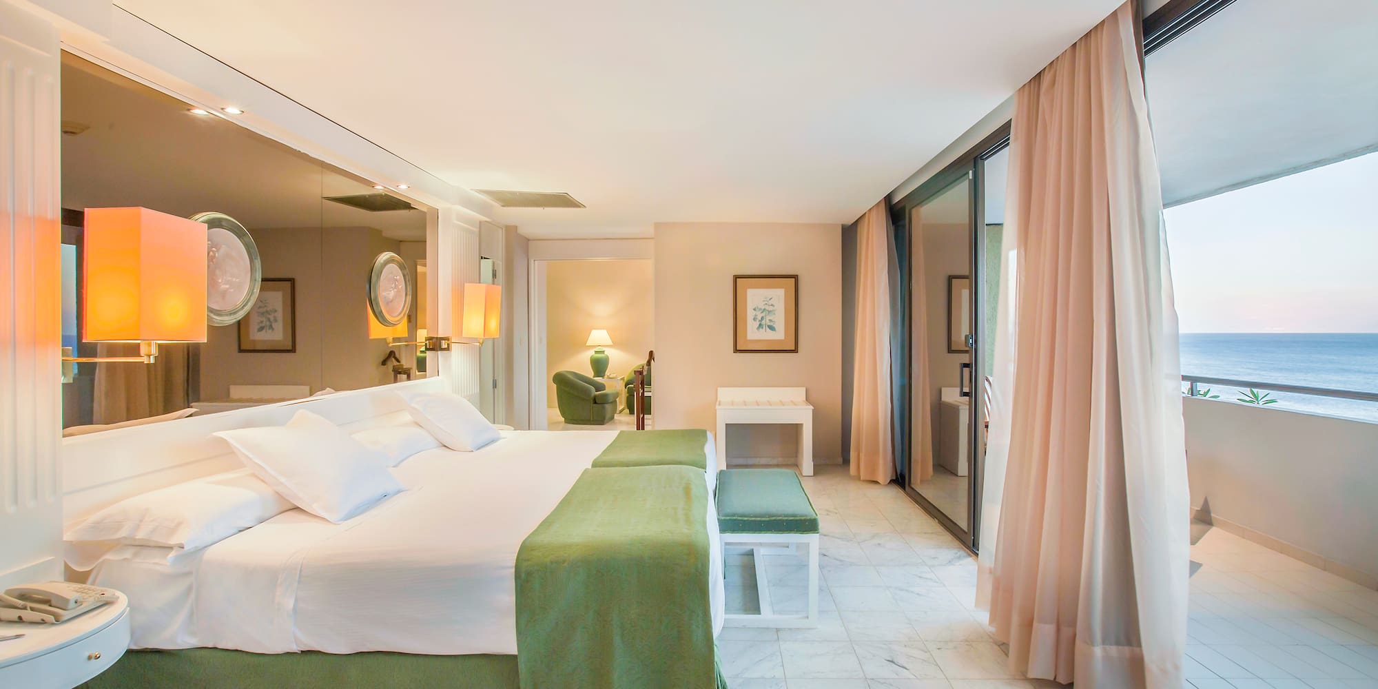 a bedroom with a large bed and a large mirror