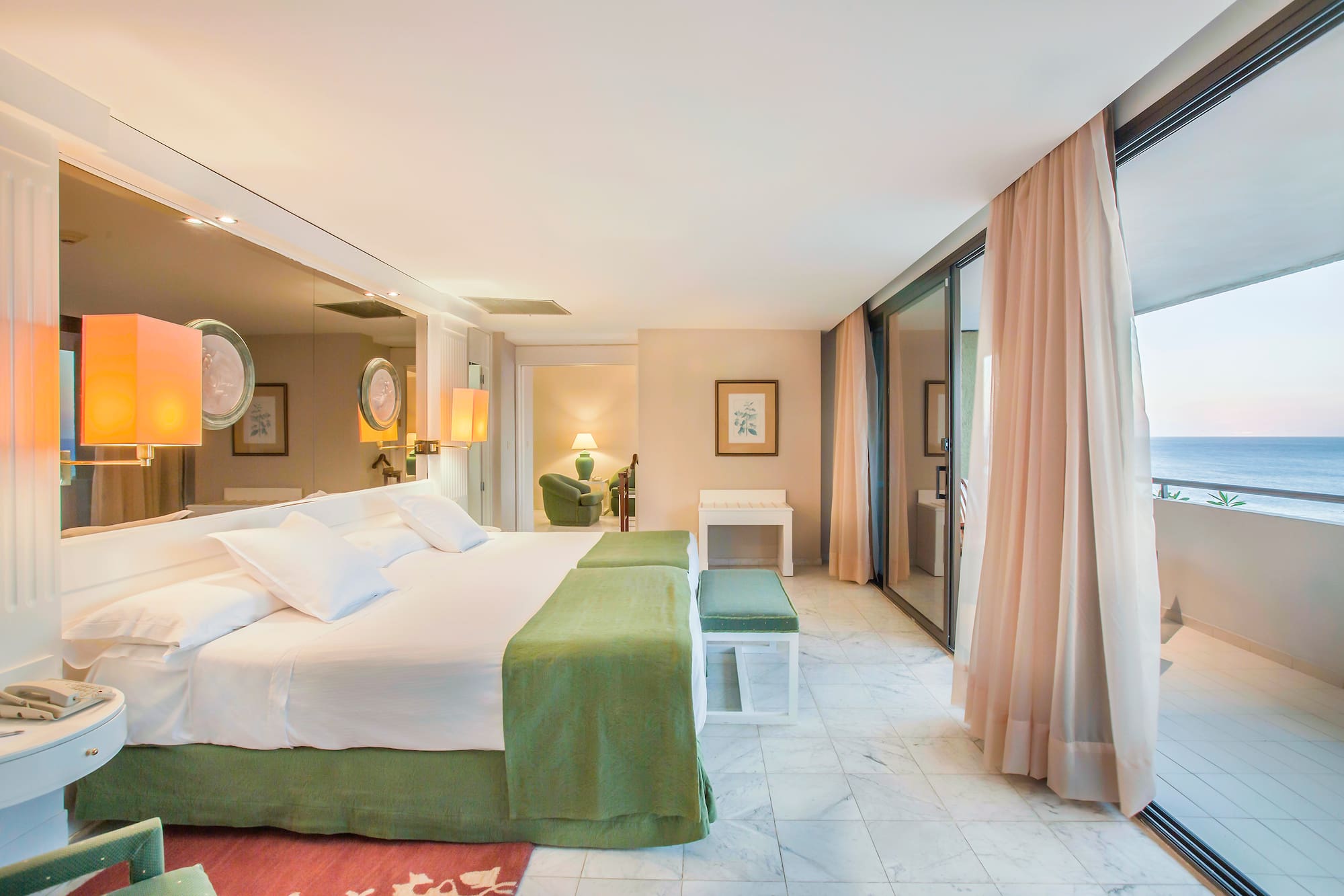 a bedroom with a large bed and a large mirror