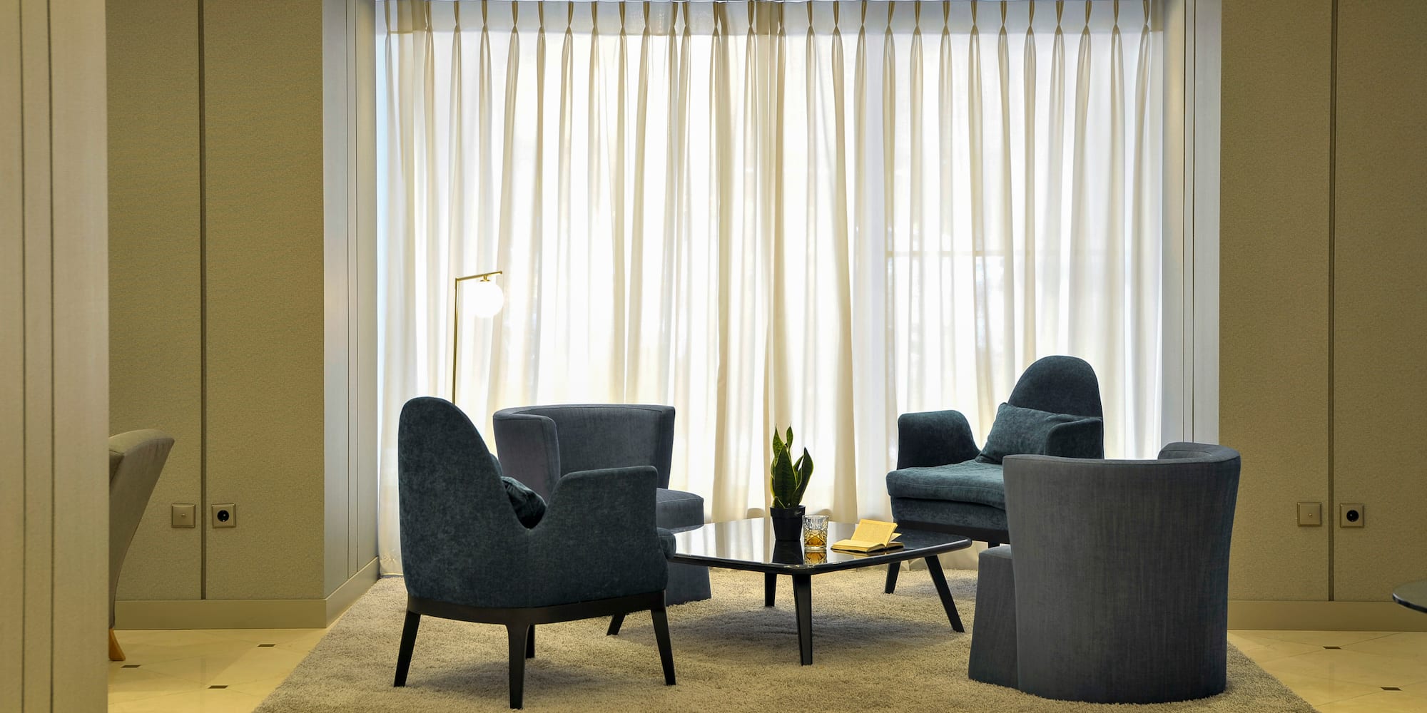 a room with a couch and chairs