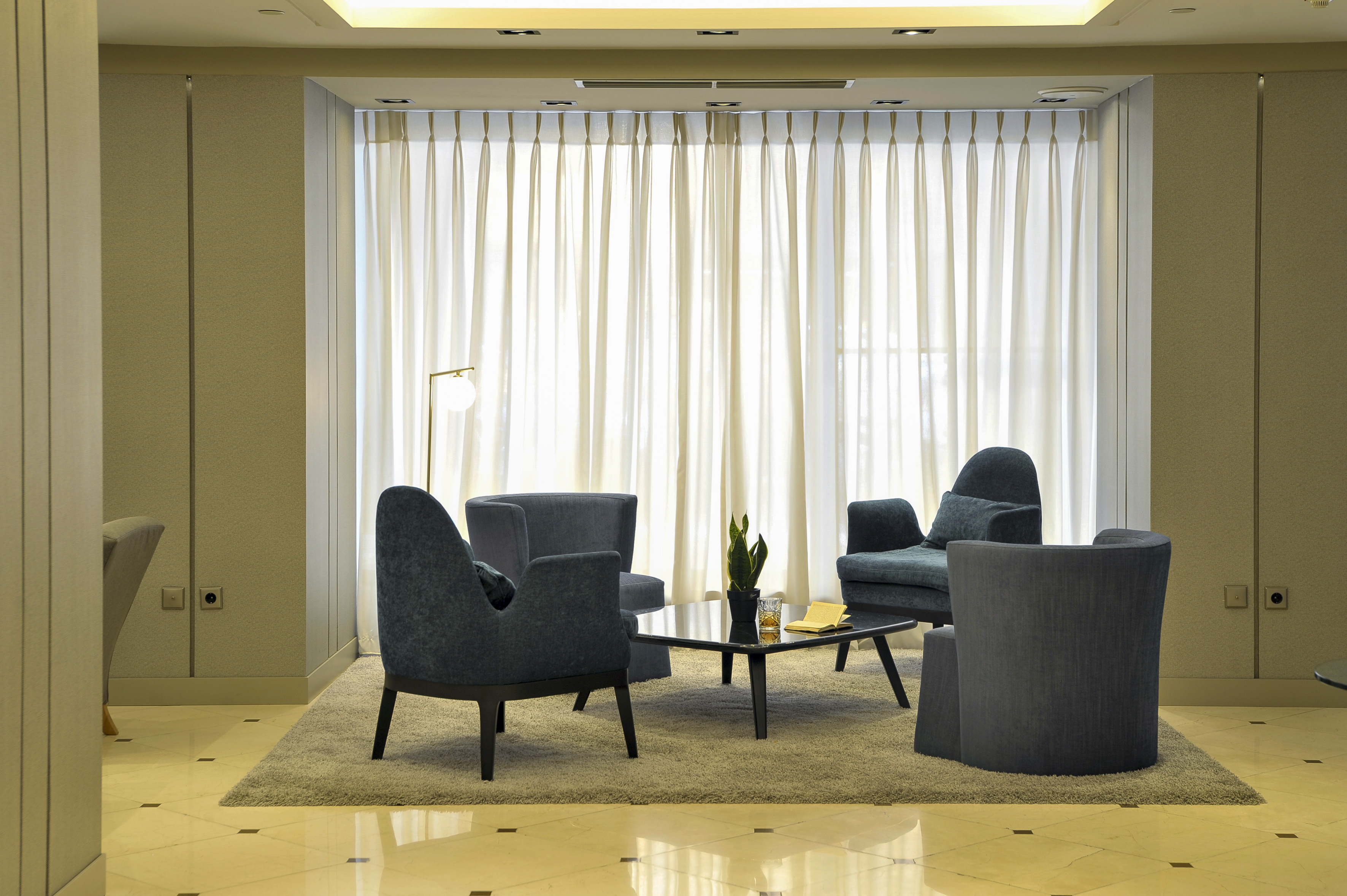 a room with a couch and chairs