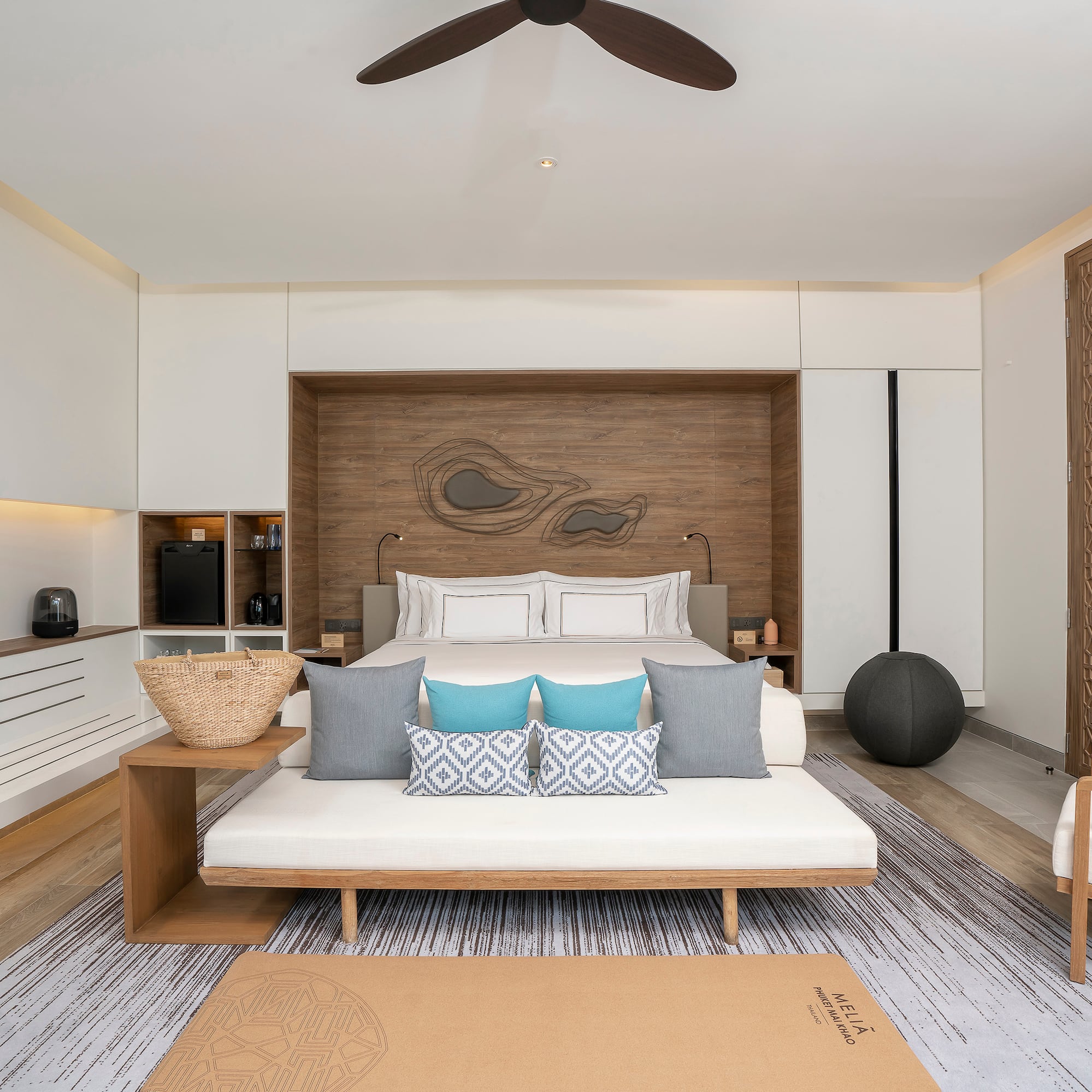 a room with a bed and a fan