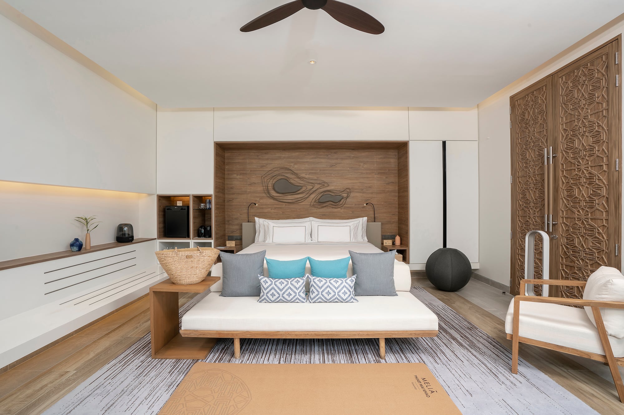 a room with a bed and a fan