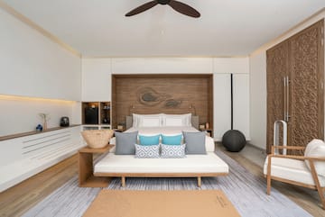 a room with a bed and a fan